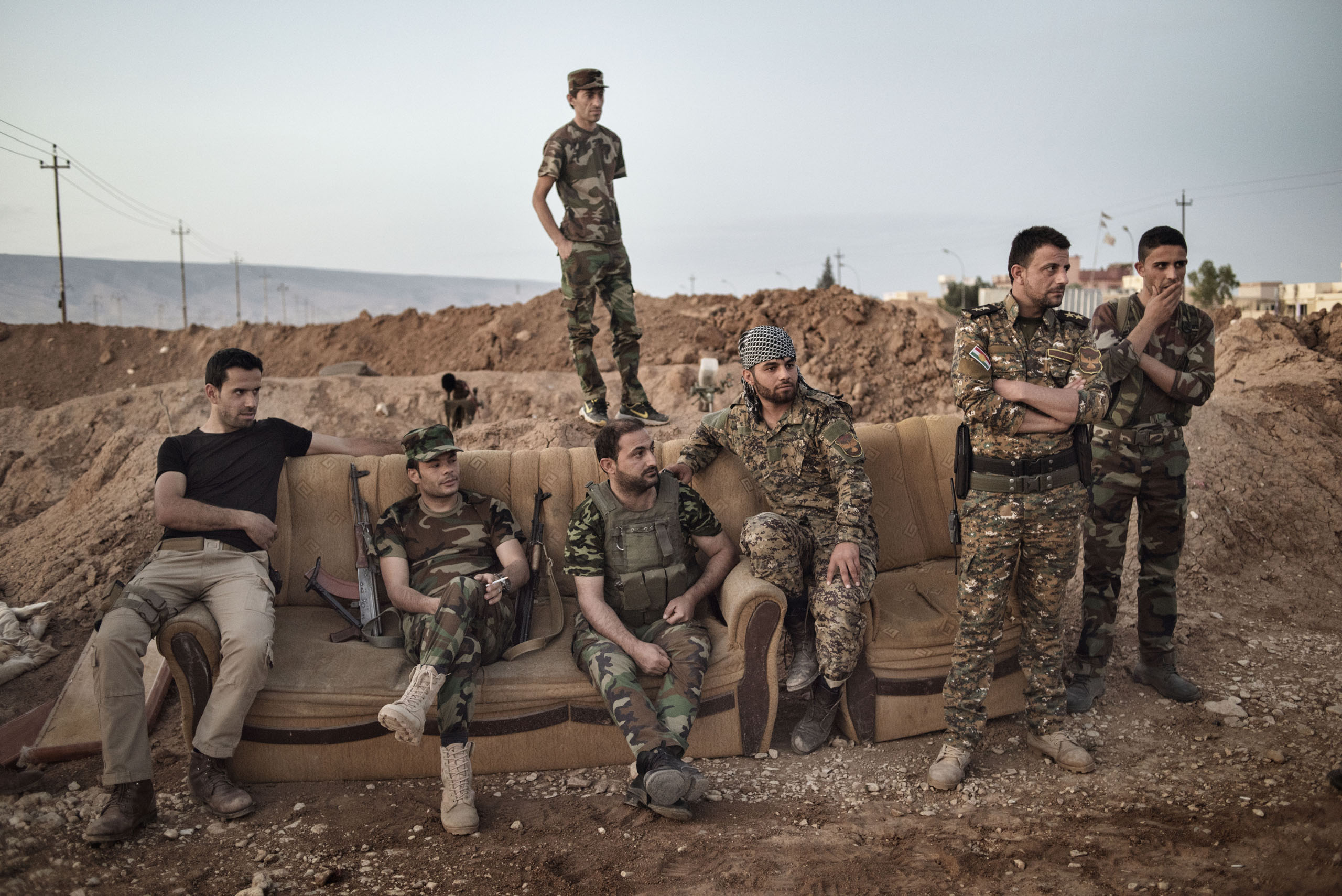 Kurdish fighters take a break while standing guard along the front line against Islamic State forces (ISIS) outside the town of Sinjar, in northern Iraq, May 12, 2016. Reclaimed by Kurdish forces in November 2015, Sinjar is a strategic point between Syri