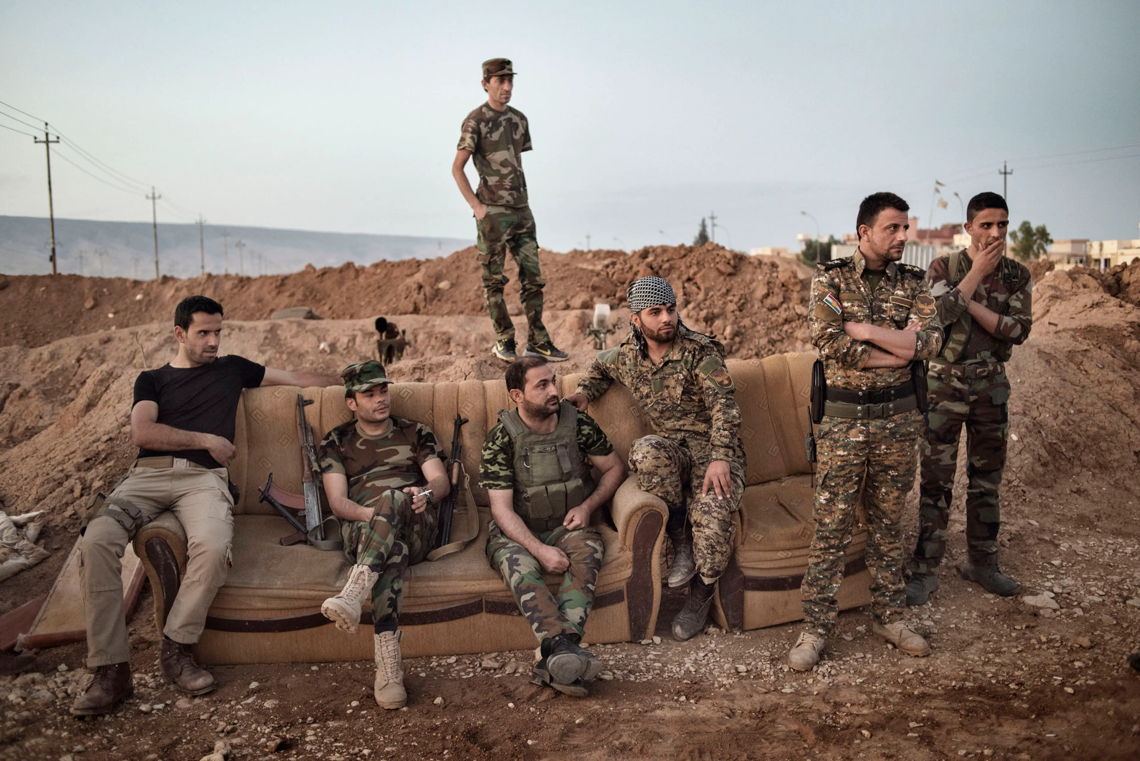 Kurdish fighters take a break while standing guard along the front line against Islamic State forces (ISIS) outside the town of Sinjar, in northern Iraq, May 12, 2016. Reclaimed by Kurdish forces in November 2015, Sinjar is a strategic point between Syri