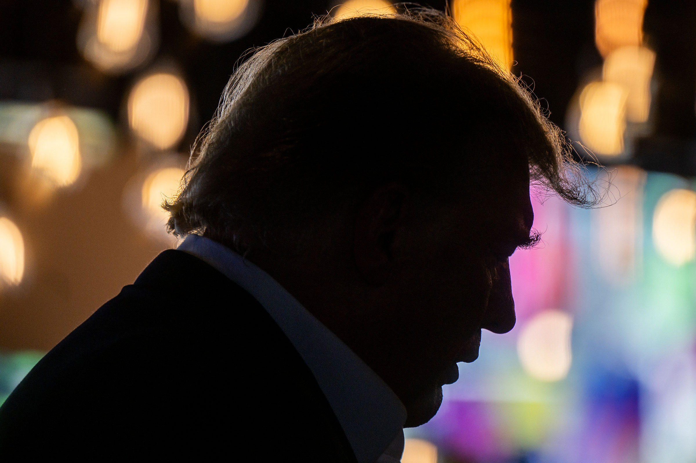 A shadowy silhouette of Donald Trump in profile