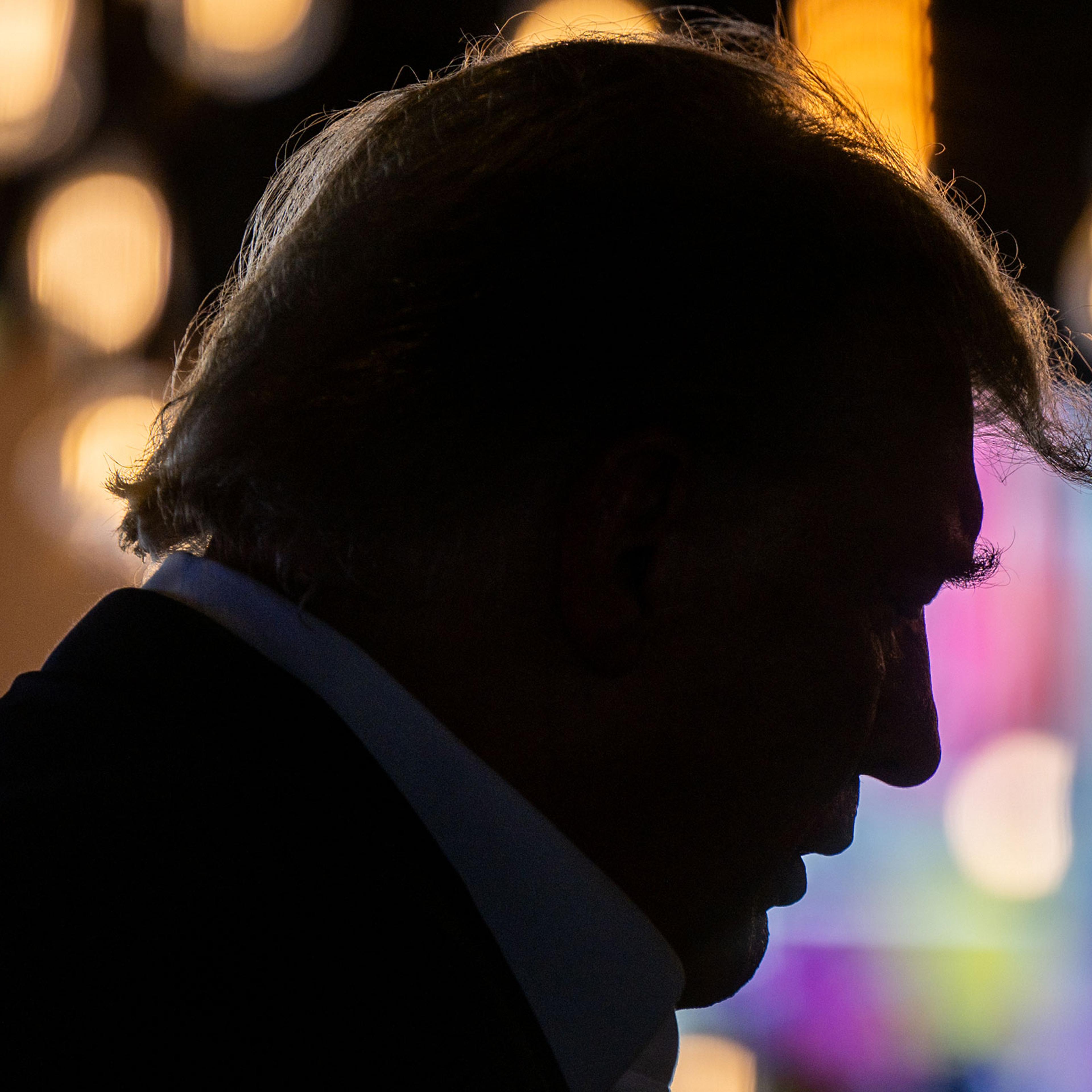 A shadowy silhouette of Donald Trump in profile