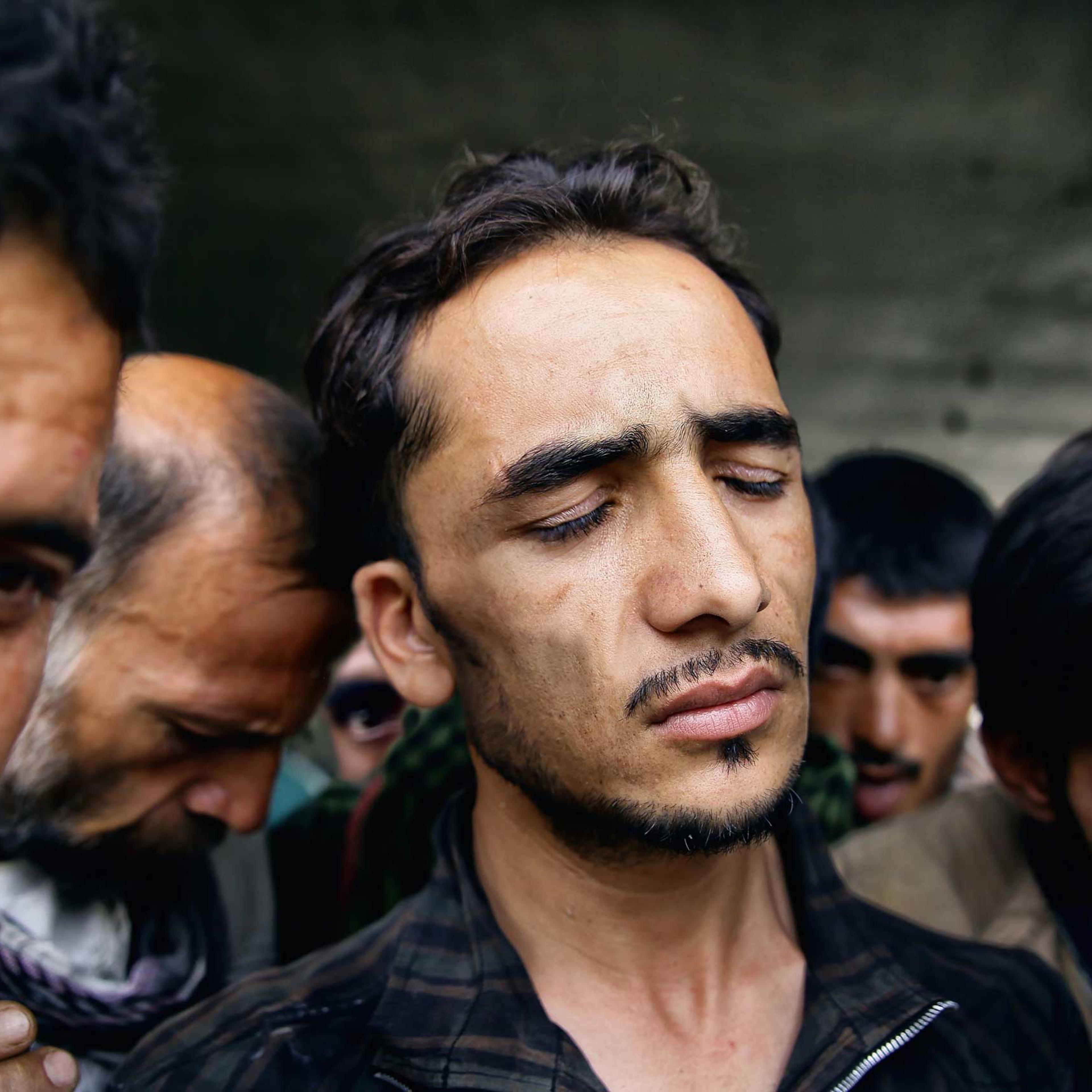Abdul Rahim Qadl grimaces in a haze after smoking a hit of opium resin under Pul-e Sukhta bridge, Kabul on Aug. 1, 2014.