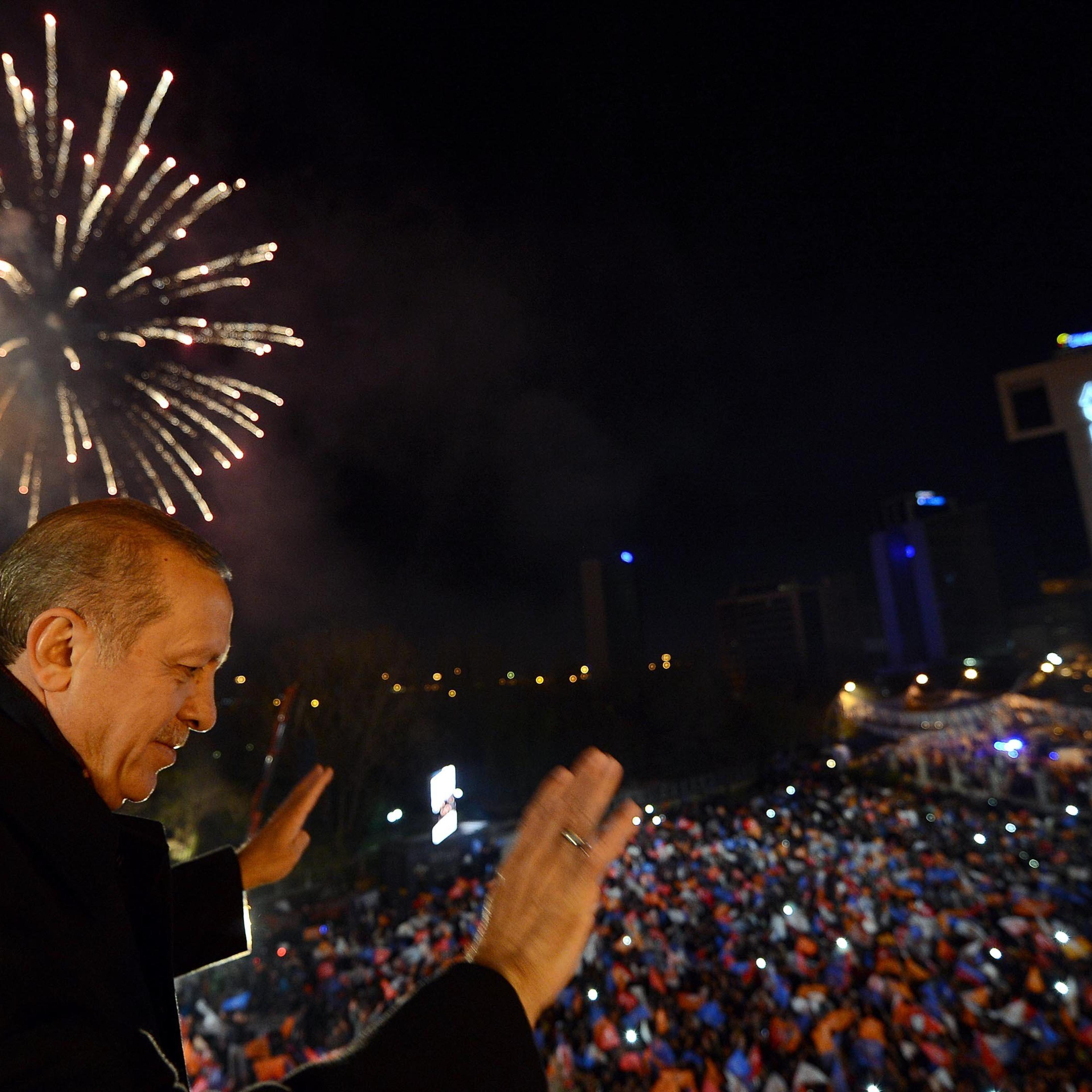 Turkey's Prime Minister Tayyip Erdogan greets his supporters in Ankara on March 30, 2014.