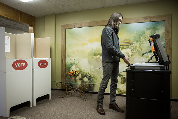 Scott Stuckey of Oklahoma City feeds a ballot into an optical scanner at Trinity Baptist Church on Super Tuesday March 1, 2016 in Oklahoma City. Oklahoma voters head to the polls for the 2016 Presidential Primary.