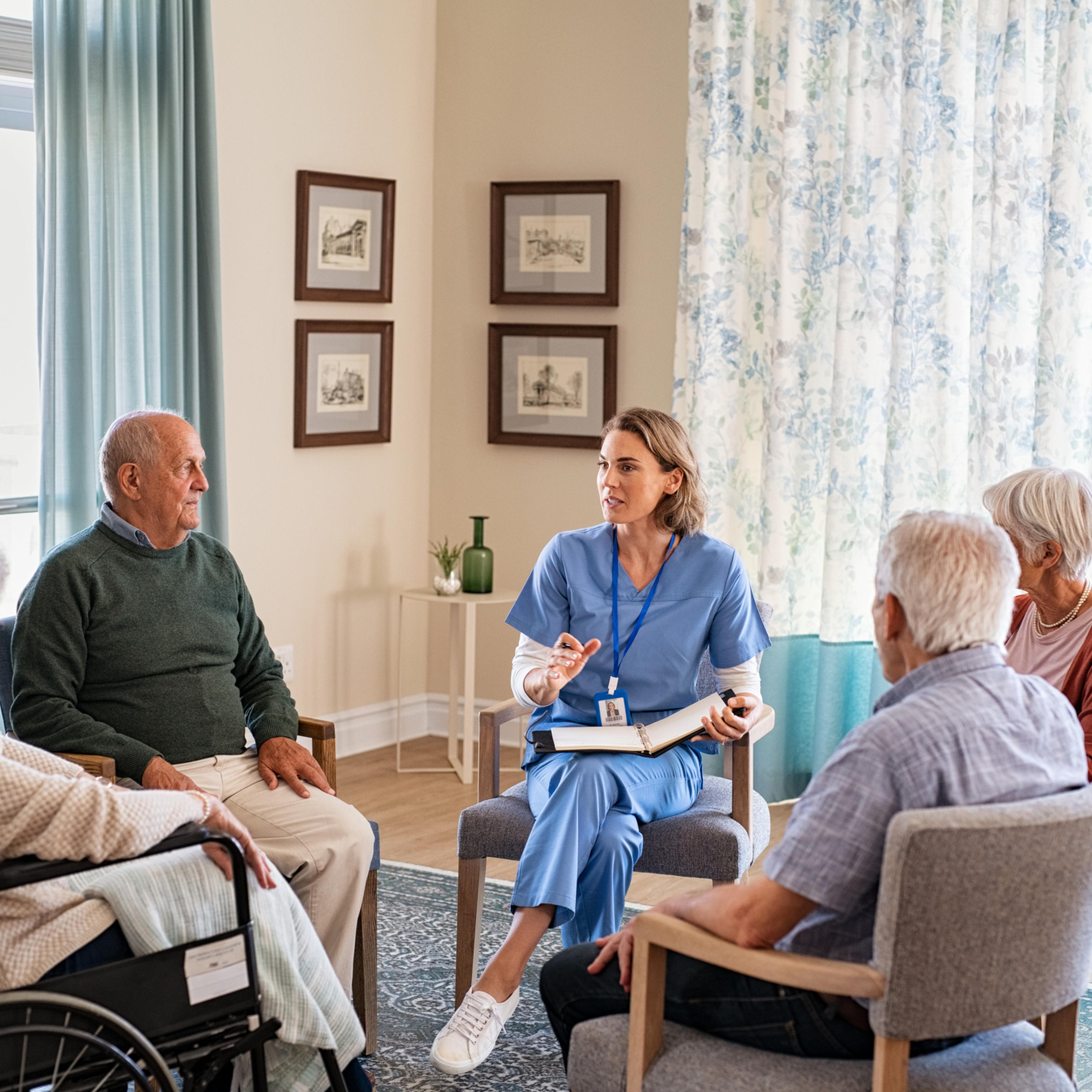 Nurse talking to senior people during group therapy