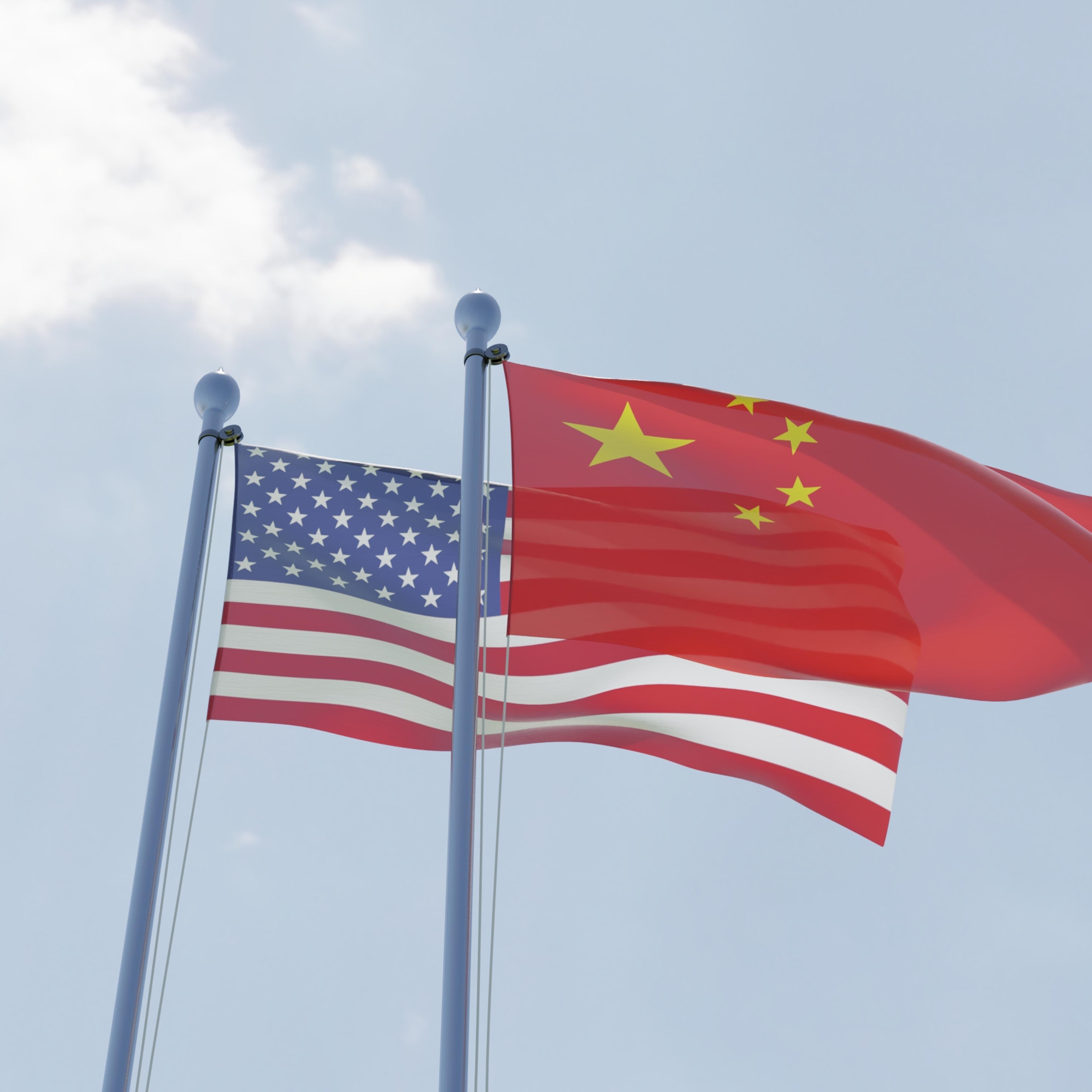 China and USA, two flags waving against blue sky