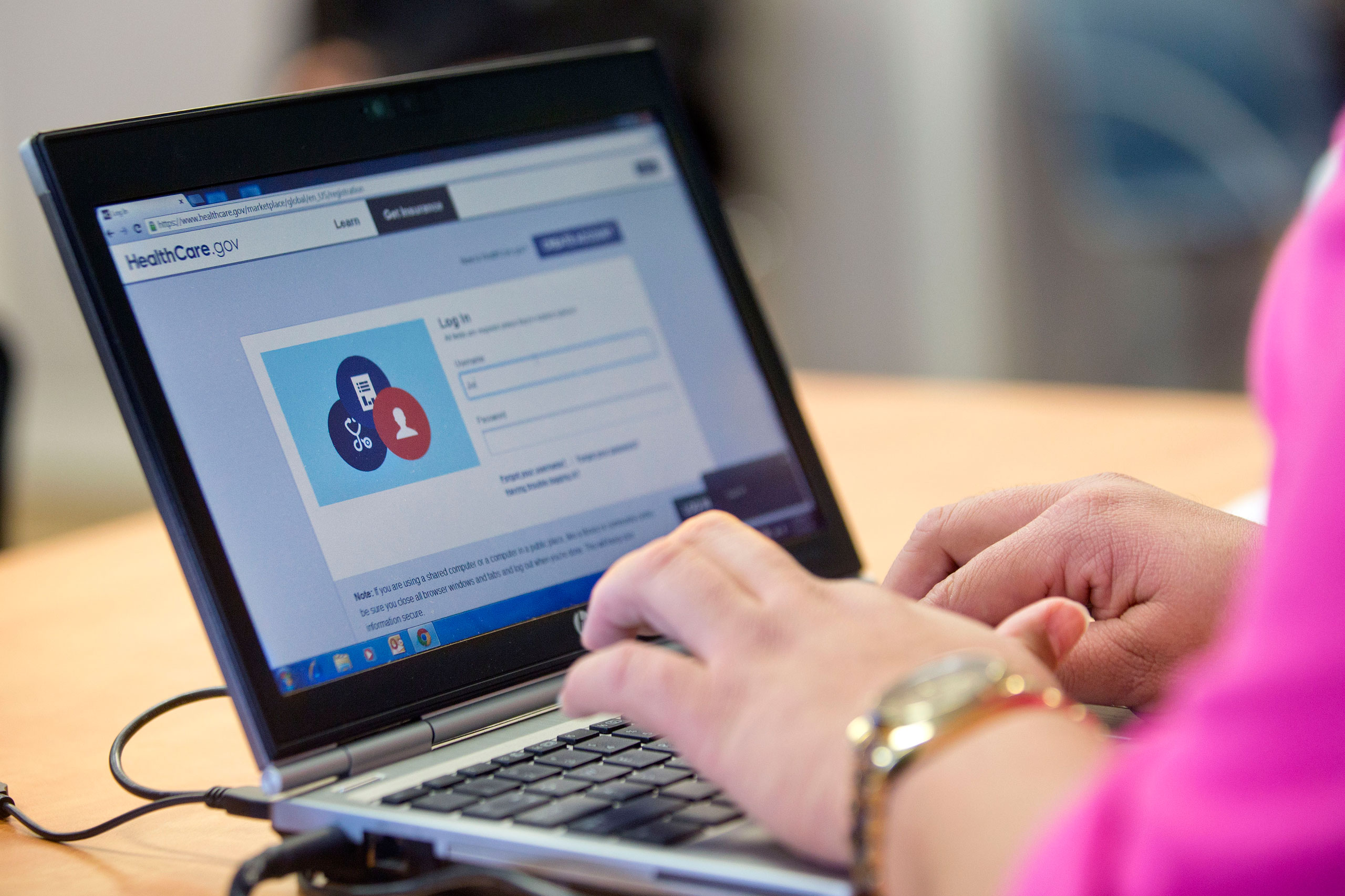 Marketplace guide Stephanie Cantres works on the Healthcare.gov federal enrollment website to help a resident sign up for a health insurance plan under the Affordable Care Act at a Westside Family Healthcare center enrollment event in Bear, Delaware, on 