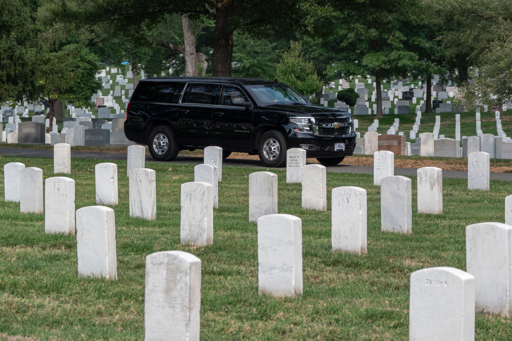 Republican presidential nominee Donald Trump rides in a SUV through Arlington National Cemetery after a wreath-laying ceremony at the Tomb of the Unknown Soldier in Arlington, Virginia, on August 26, 2024.
