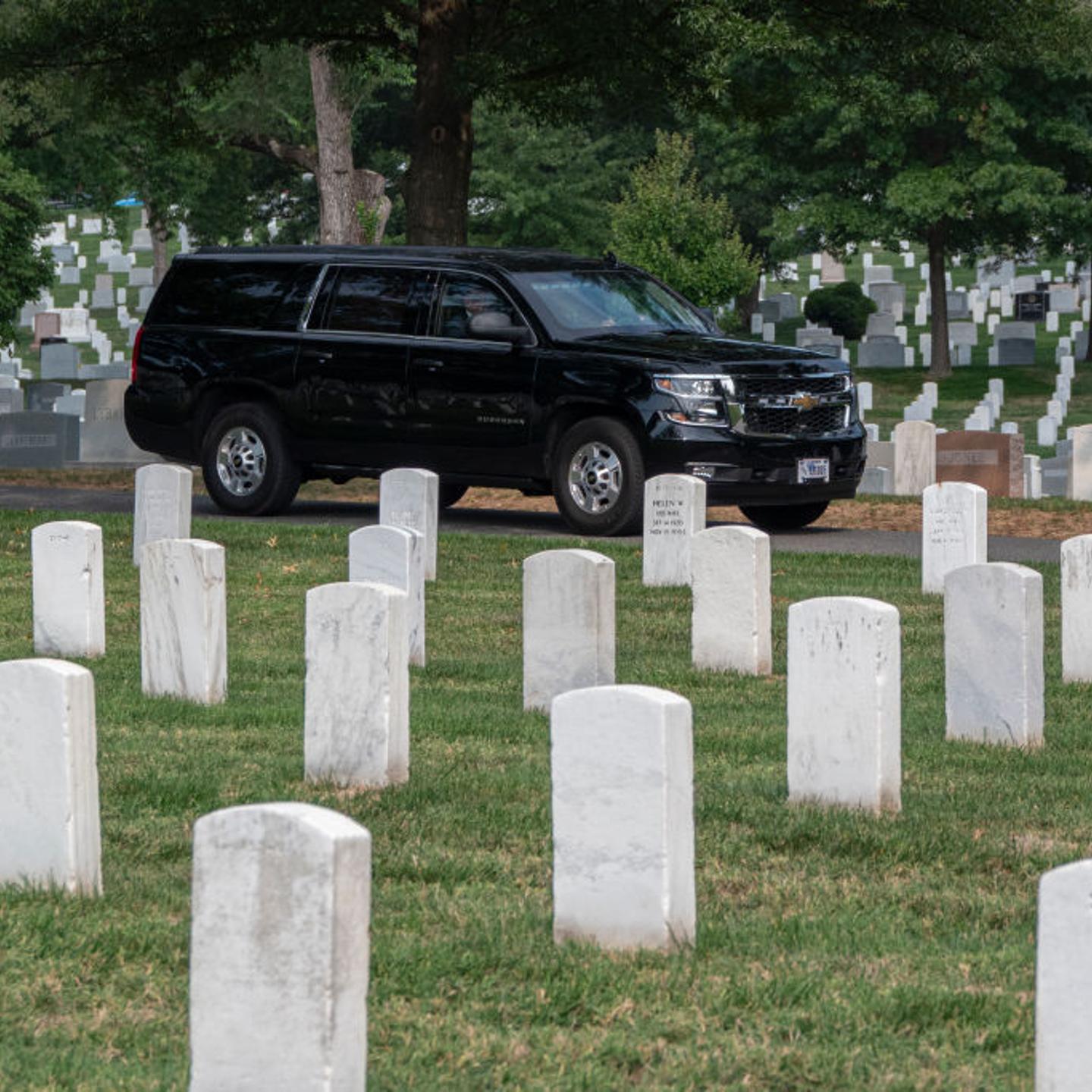 Republican presidential nominee Donald Trump rides in a SUV through Arlington National Cemetery after a wreath-laying ceremony at the Tomb of the Unknown Soldier in Arlington, Virginia, on August 26, 2024.