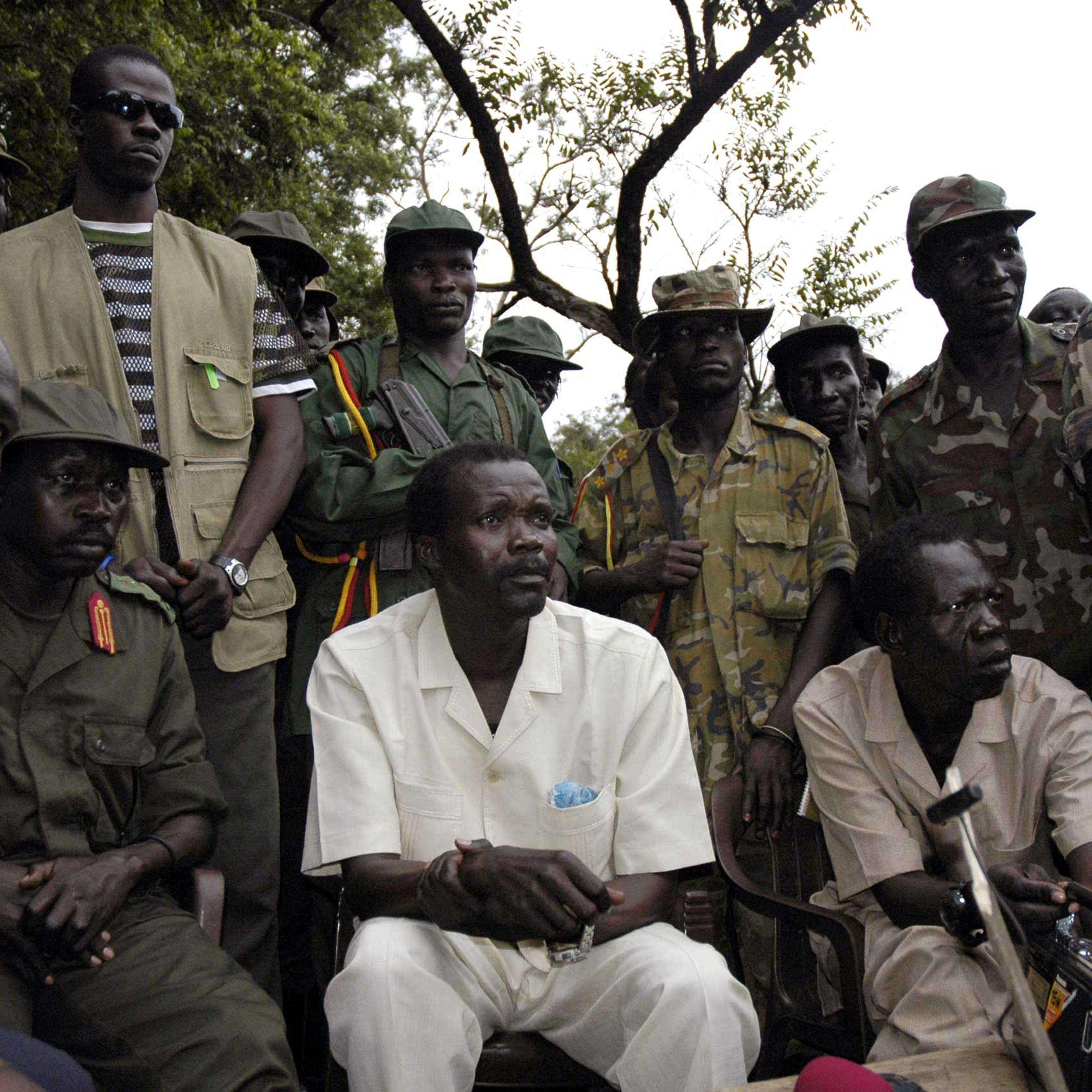 The leader of Uganda's Lord's Resistance Army rebels Joseph Kony (seated C), surrounded by his officers, addresses his first news conference in 20 years of rebellion in Nabanga, Sudan, on Aug. 1, 2006.