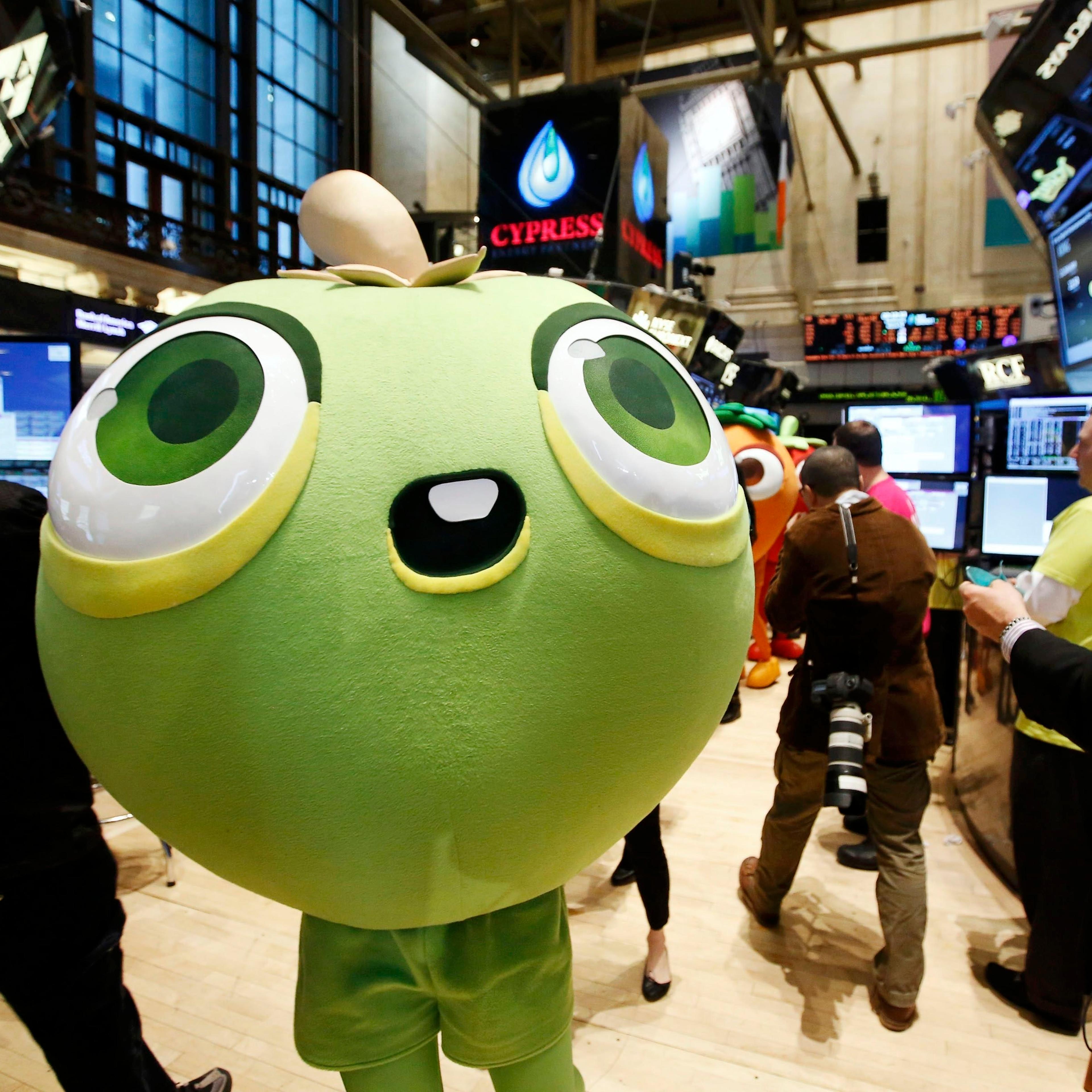 A mascot dressed as a character from the mobile game "Candy Crush Saga" walks the floor of the New York Stock Exchange during the IPO of Mobile game maker King Digital Entertainment Plc