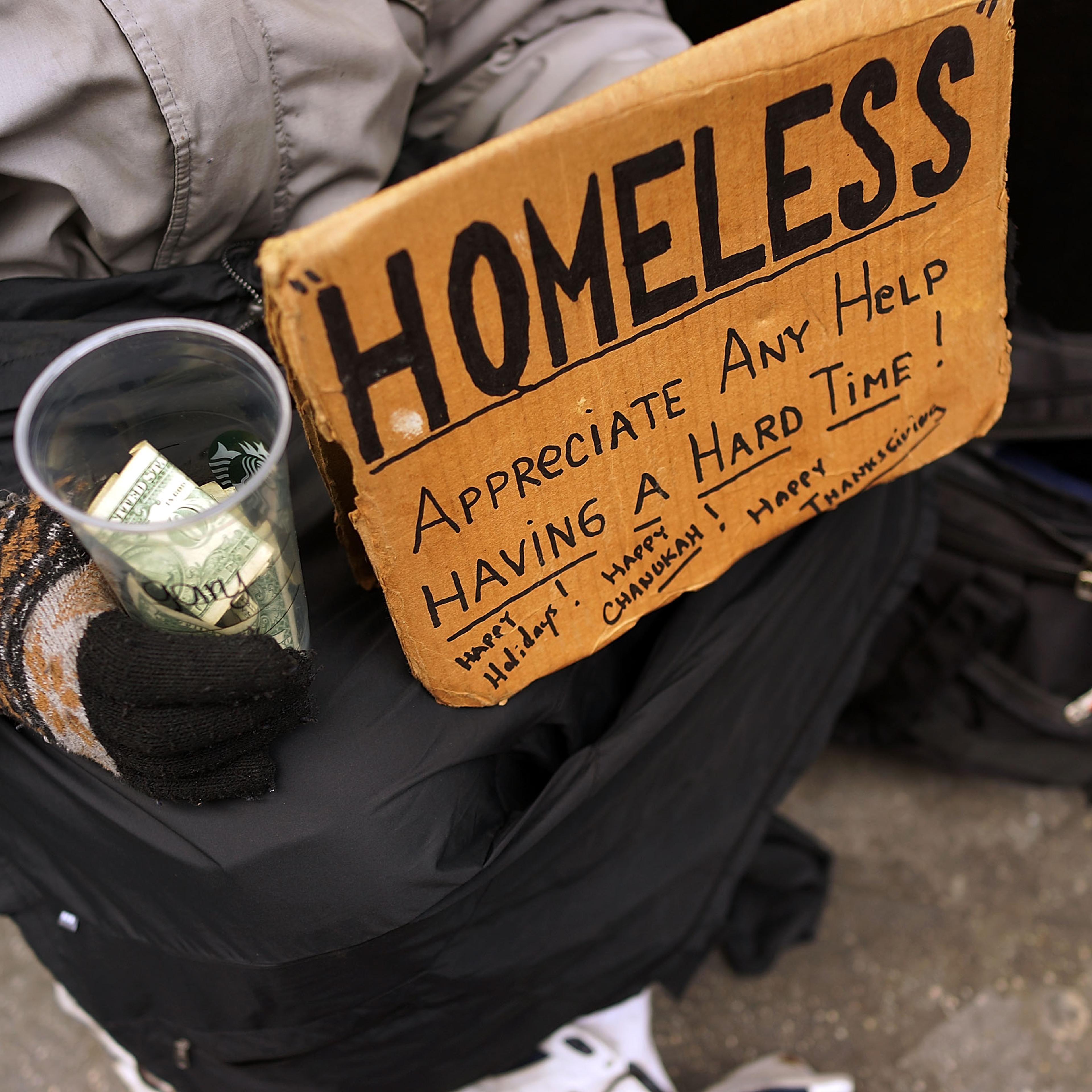 Panhandlers' Placards Show Signs Of Continued Economic Hardship