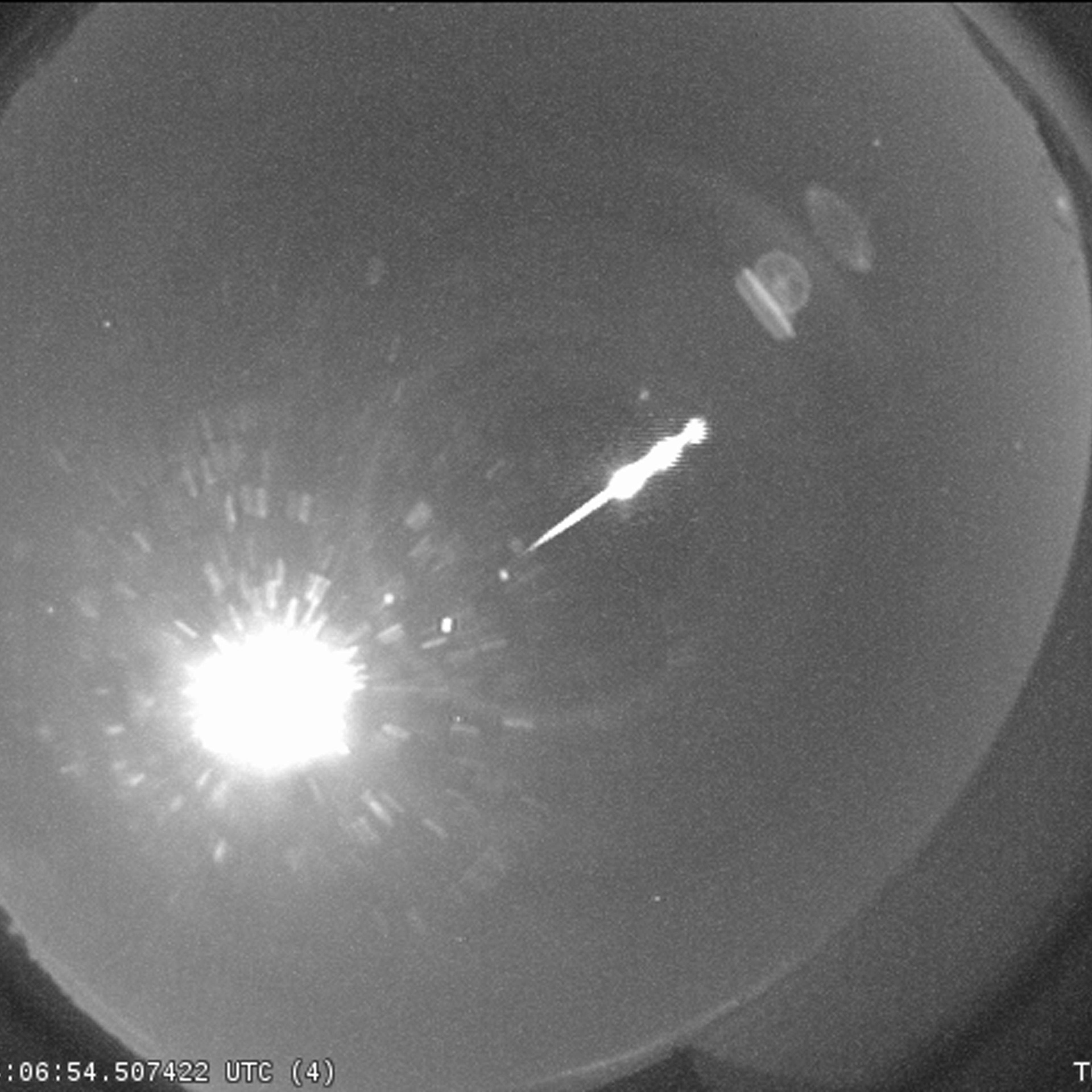A bright Taurid fireball recorded by the NASA All Sky Fireball Network station in Cartersville, Georgia, in 2013. The bright orb is the Moon.