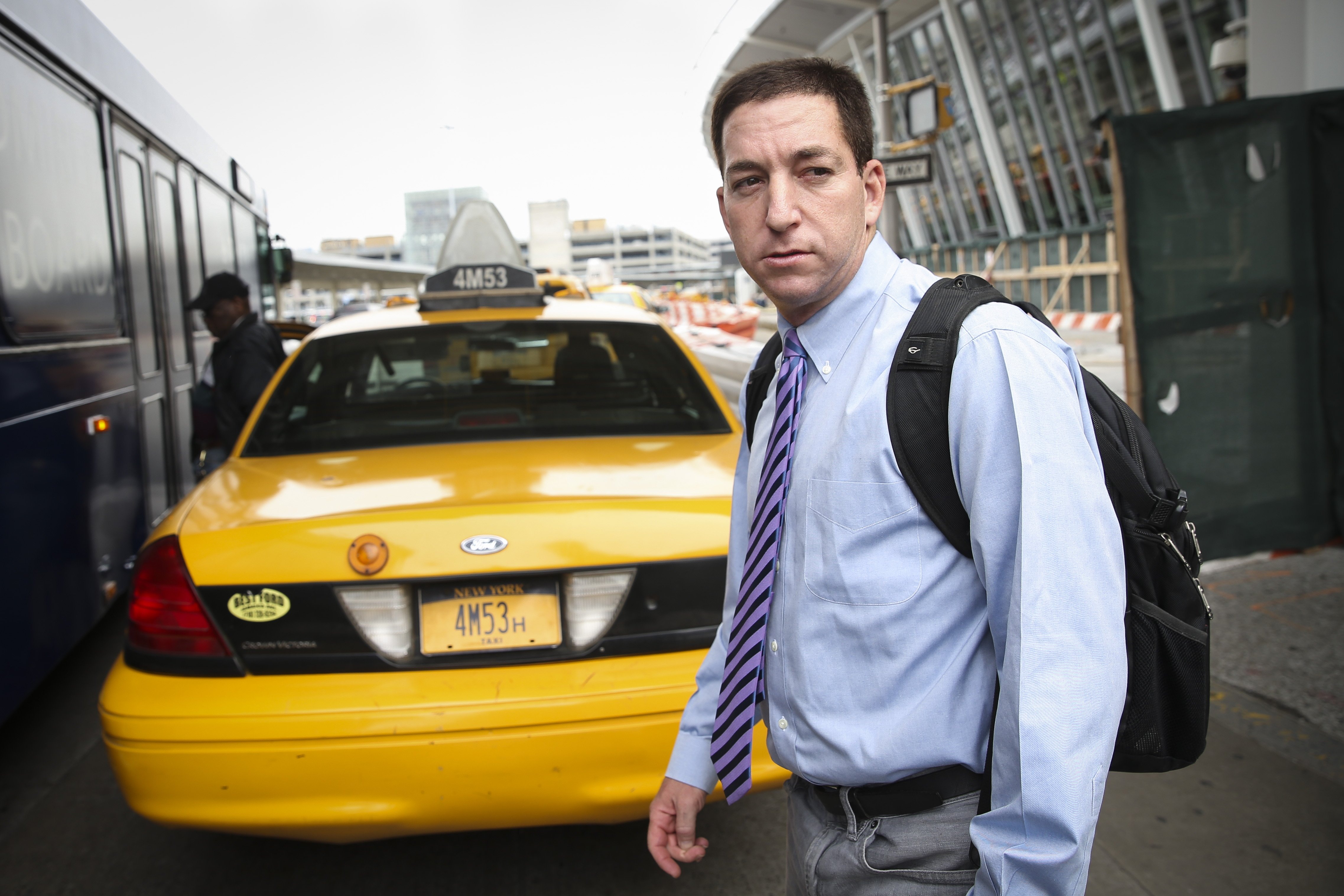 Glenn Greenwald arrives at John F. Kennedy International Airport in New York.