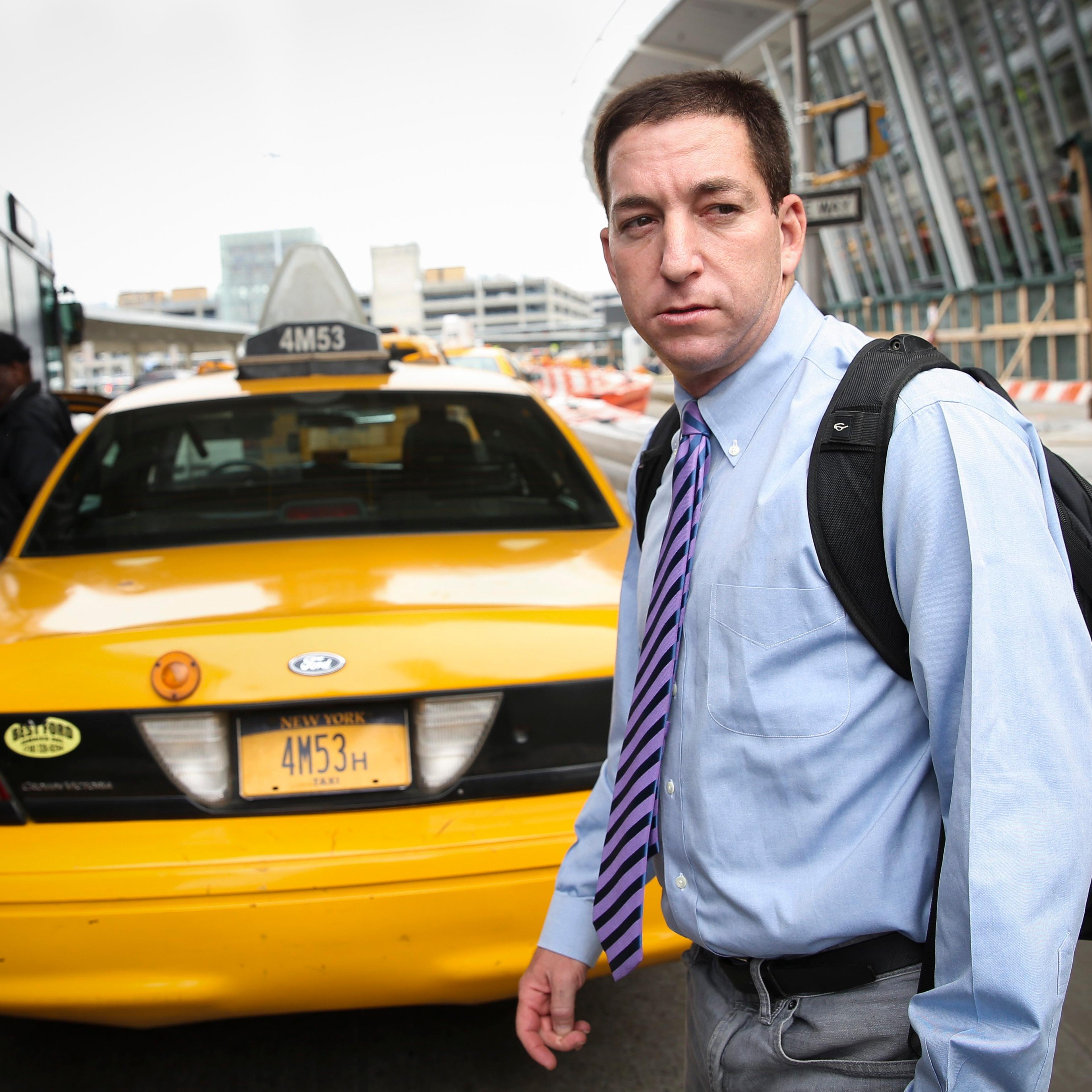 Glenn Greenwald arrives at John F. Kennedy International Airport in New York.