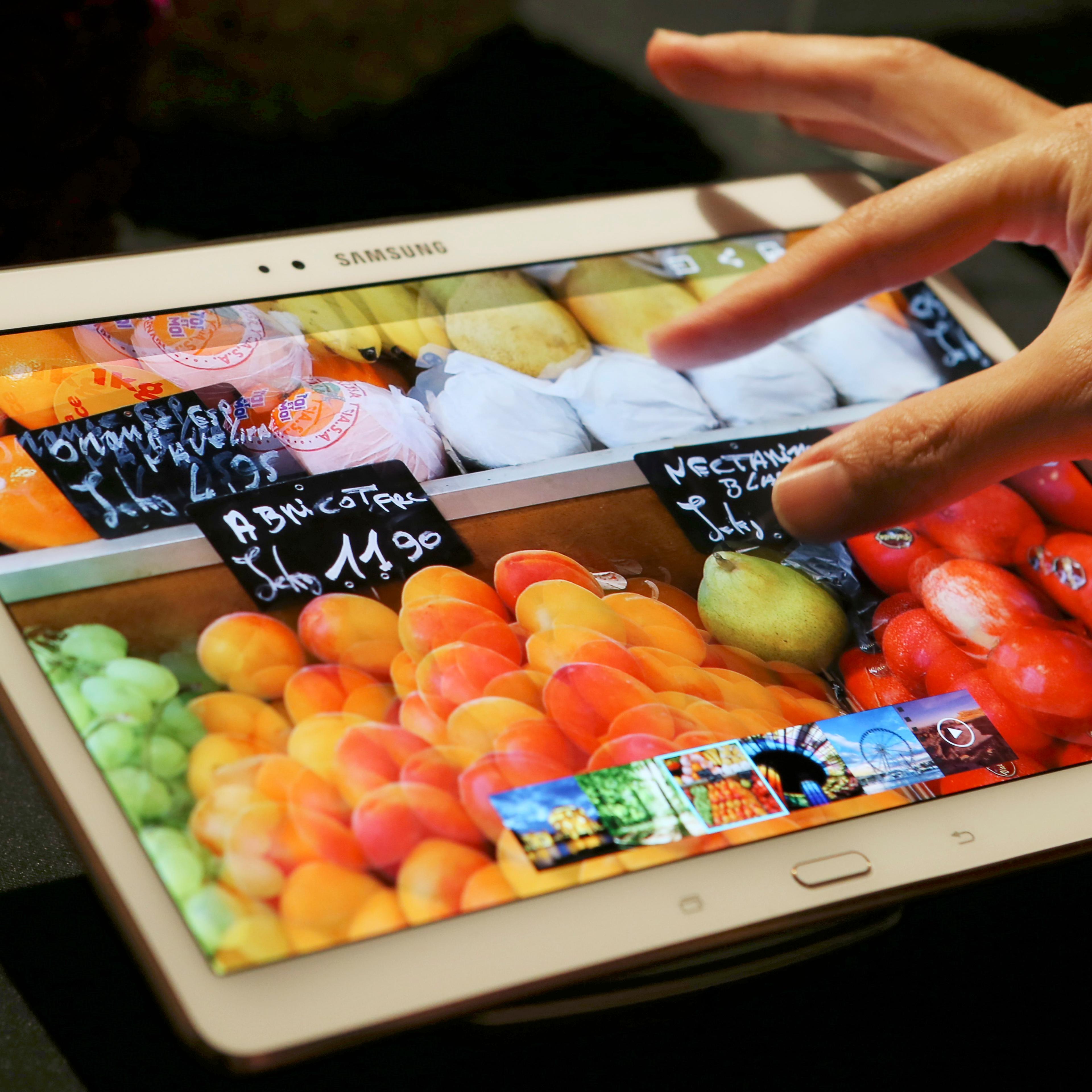 A visitor tries out Samsung Electronics Co.'s 10.5-inch Galaxy Tab S tablet during an event in Tokyo, Japan on July 31, 2014.