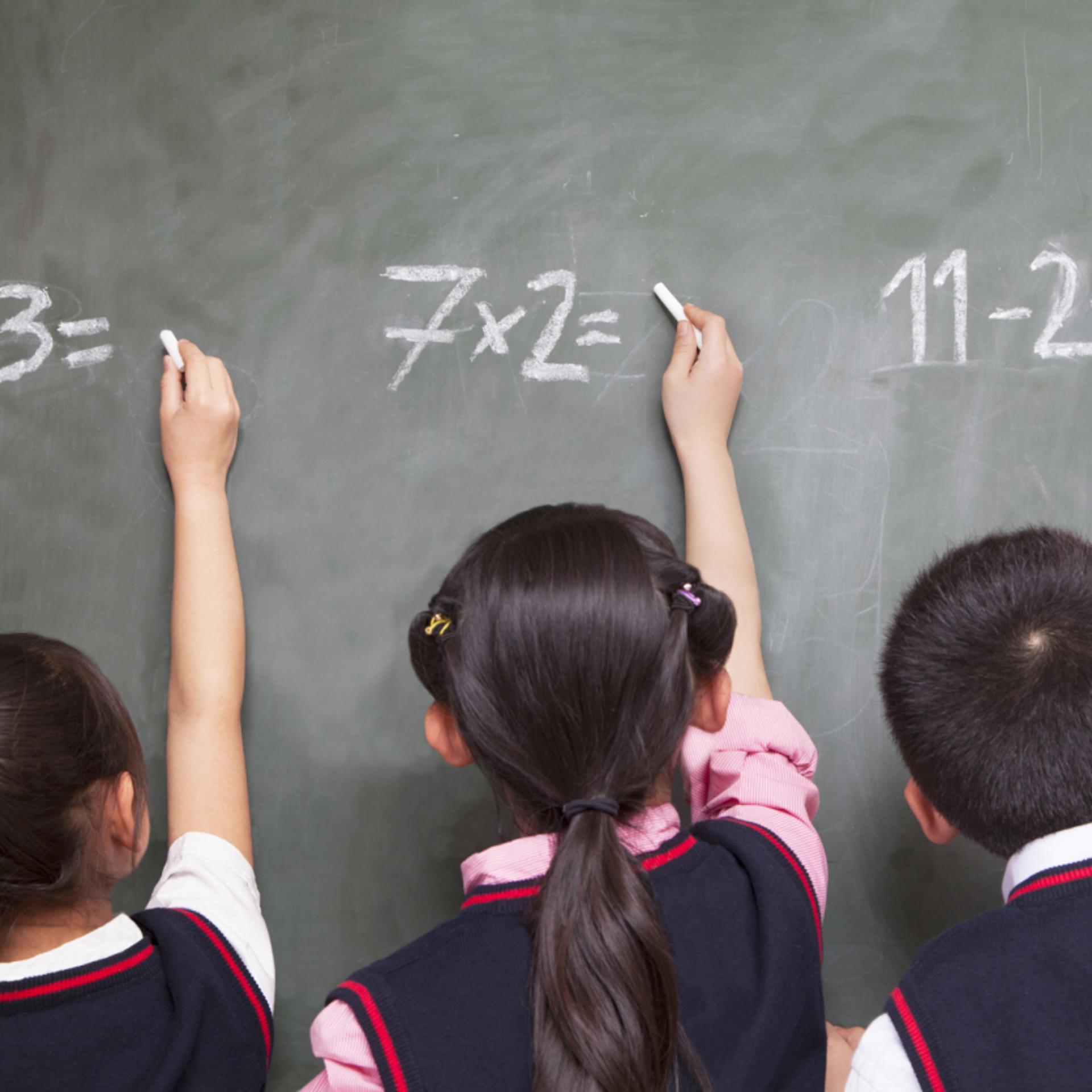 young student solve math problems