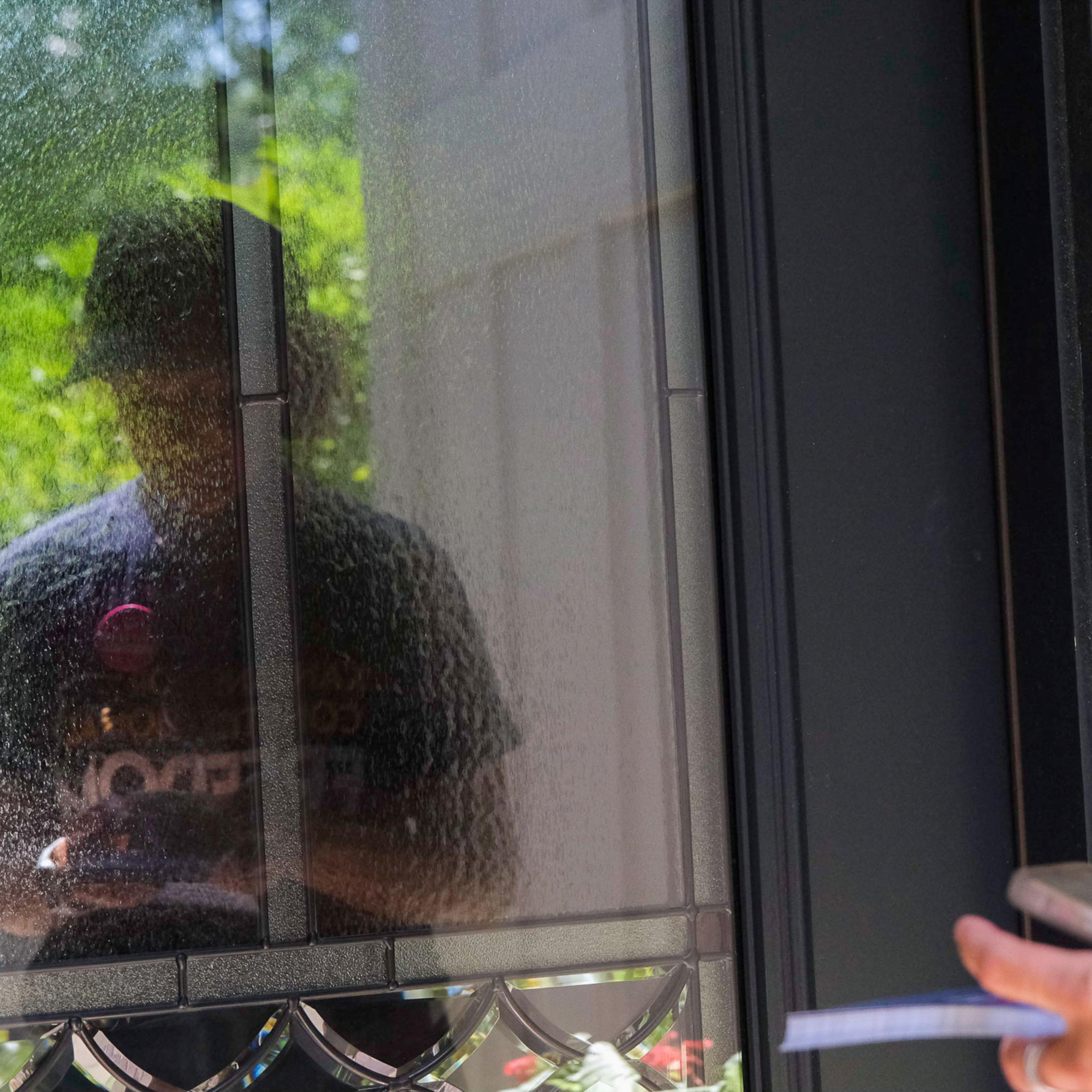Anne Melia waits at the door while canvassing for Kansans for Constitutional Freedom in Leawood, Kansas on July 23, 2022. Arin Yoon for TIME.