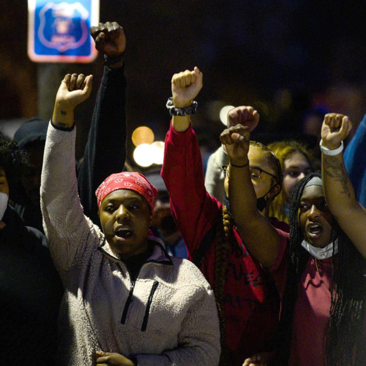 Demonstrators chant around a chalk circle that says Justice for Daunte Wright on April 11, 2021 in Brooklyn Center, Minnesota