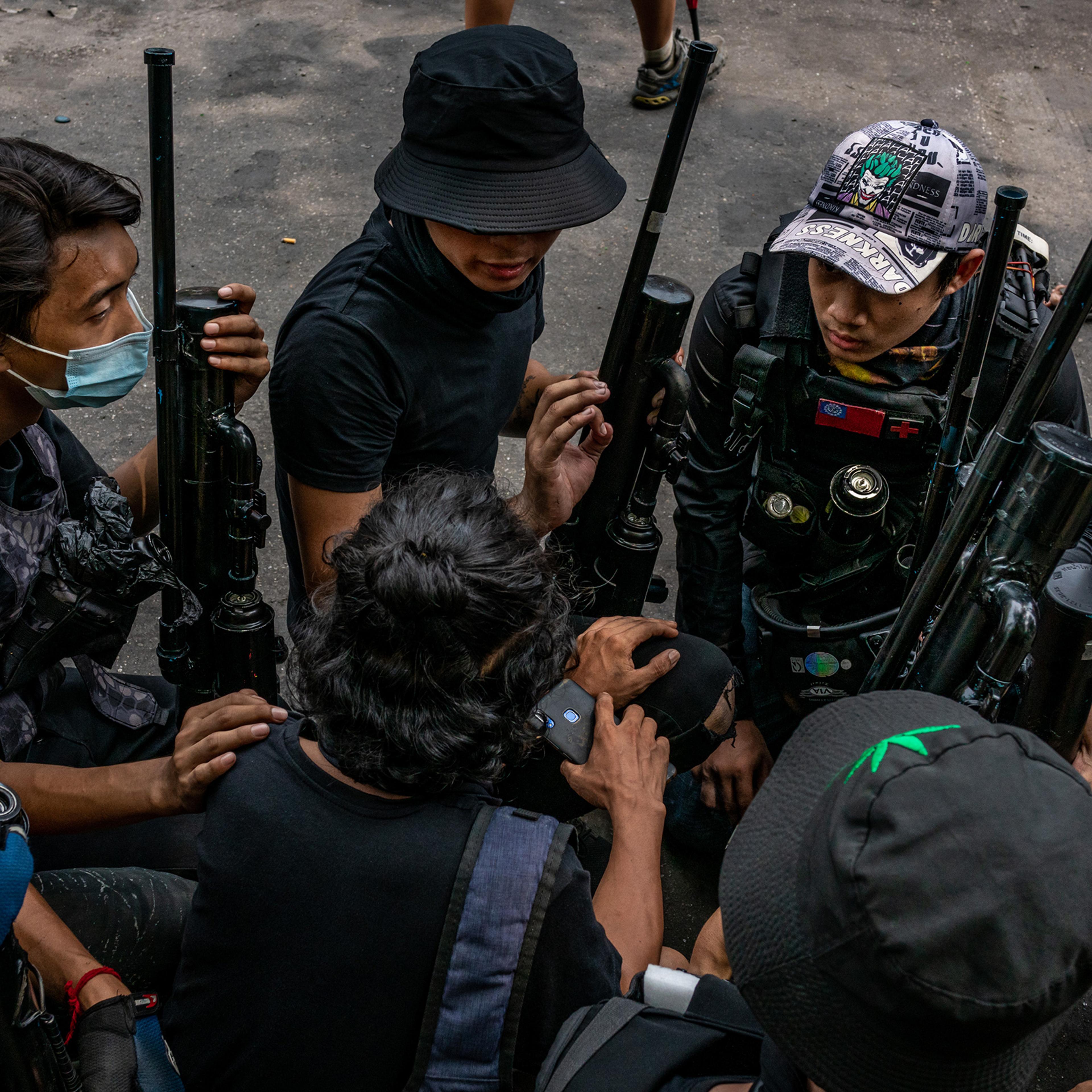 Anti-coup protesters hold improvised weapons during a protest in Yangon, Myanmar, on April 3, 2021.