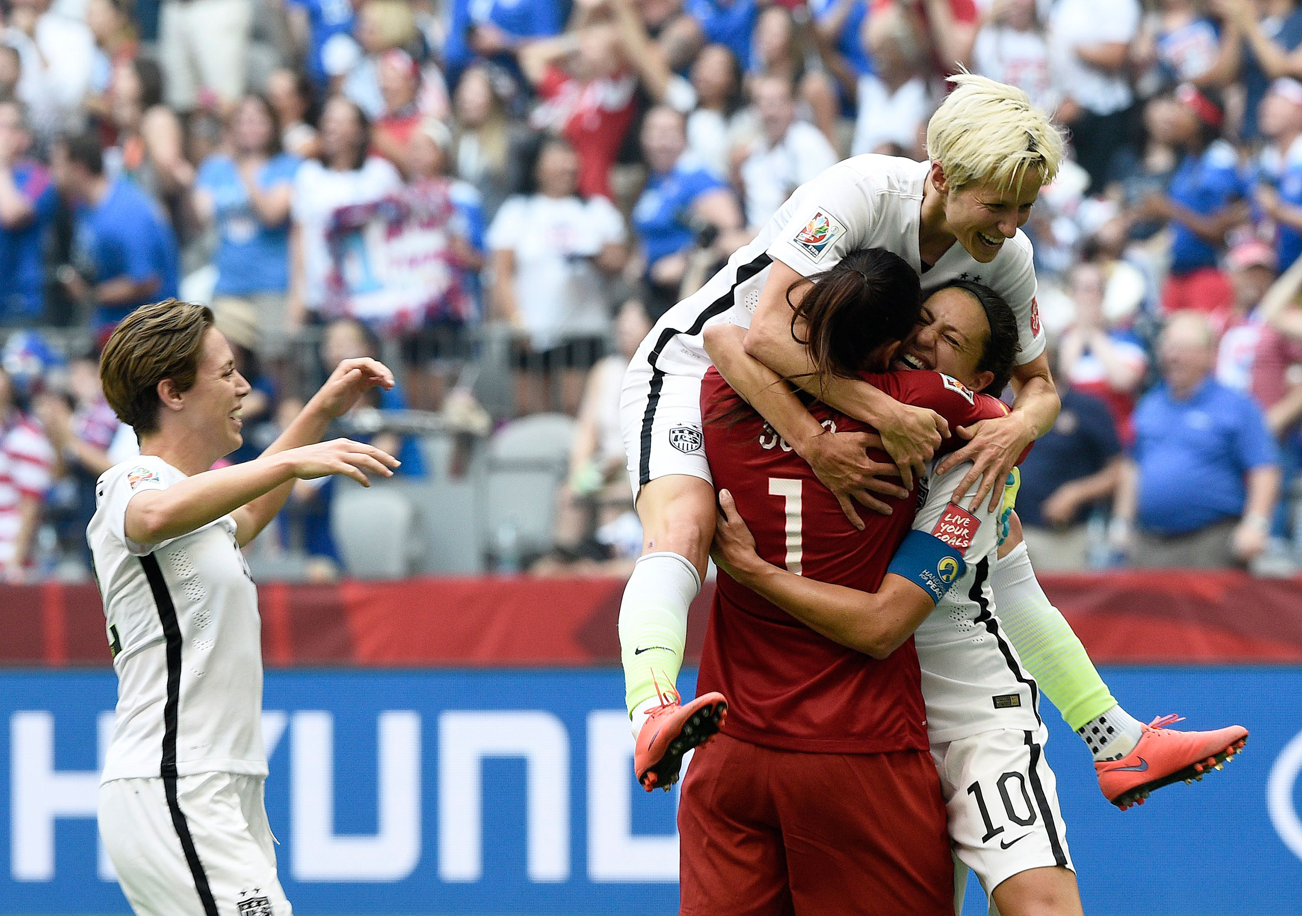 Carli Lloyd (10) is congratulated by goalkeeper Hope Solo (1) and midfielder Megan Rapinoe (top) after scoring a goal during the final match between USA and Japan during the 2015 FIFA Women's World Cup at the BC Place Stadium in Vancouver, Canada, July 5