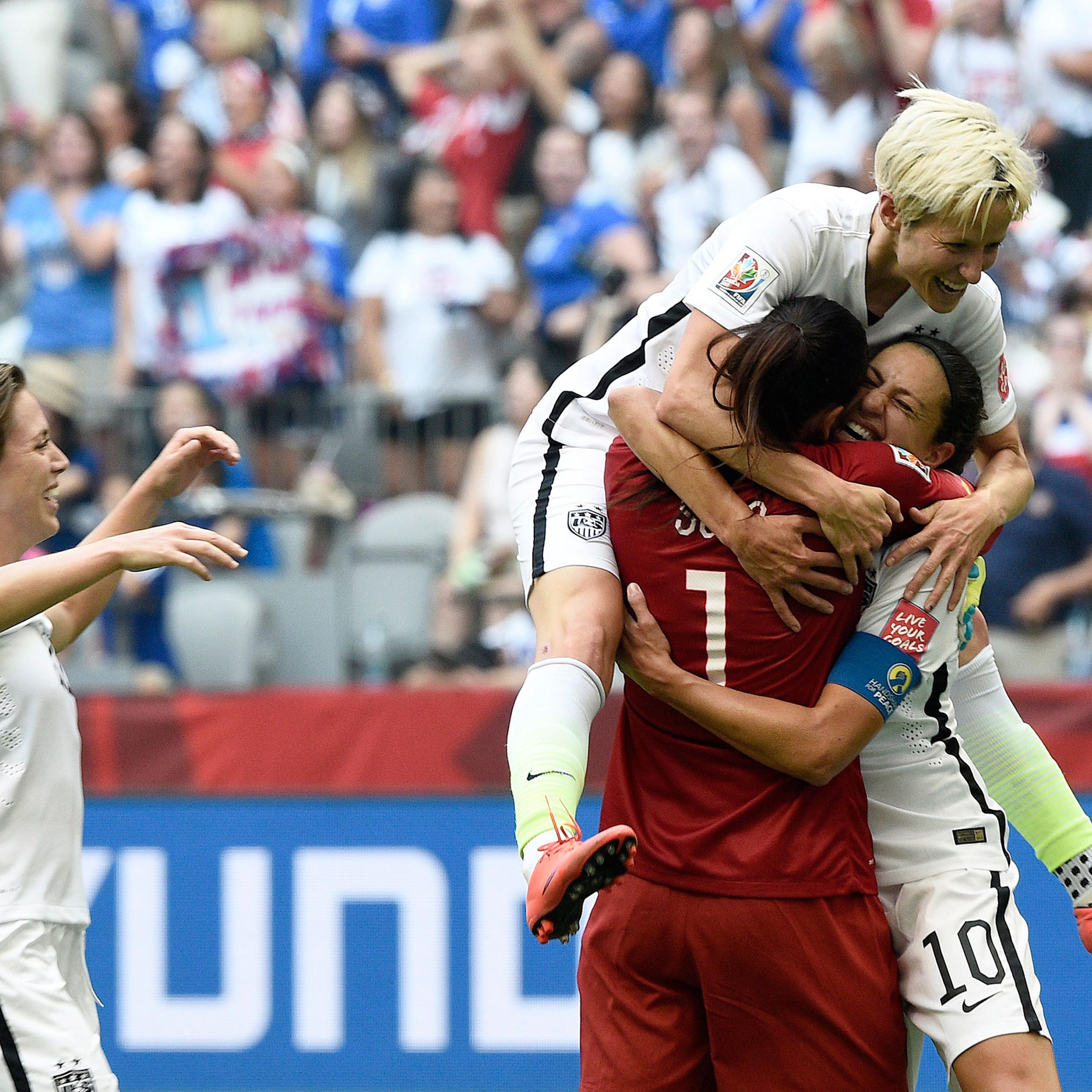 Carli Lloyd (10) is congratulated by goalkeeper Hope Solo (1) and midfielder Megan Rapinoe (top) after scoring a goal during the final match between USA and Japan during the 2015 FIFA Women's World Cup at the BC Place Stadium in Vancouver, Canada, July 5