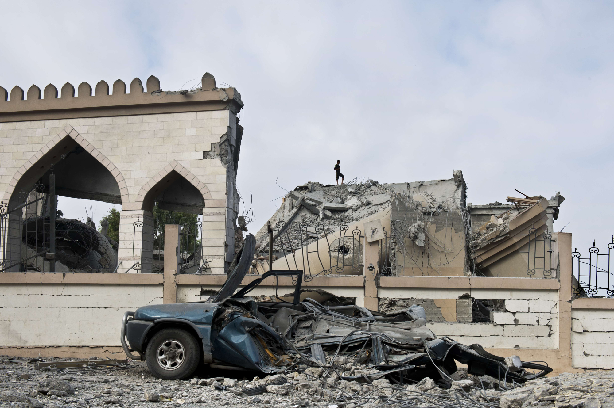 A Palestinian walks on the rubble of a mosque that was partially damaged by an airstrike on Aug. 25, 2014 in Beit Lahia in the northern Gaza Strip.