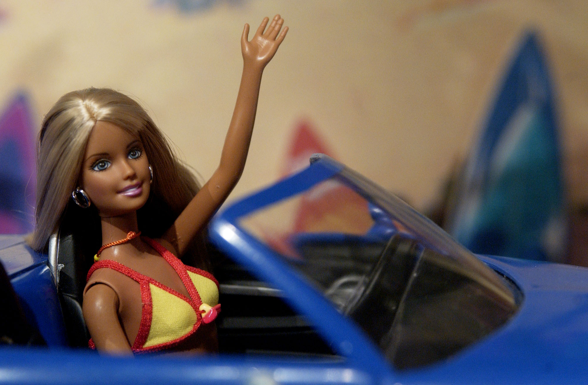 Cali Girl Barbie waves from the front seat of a Chevy SSR du