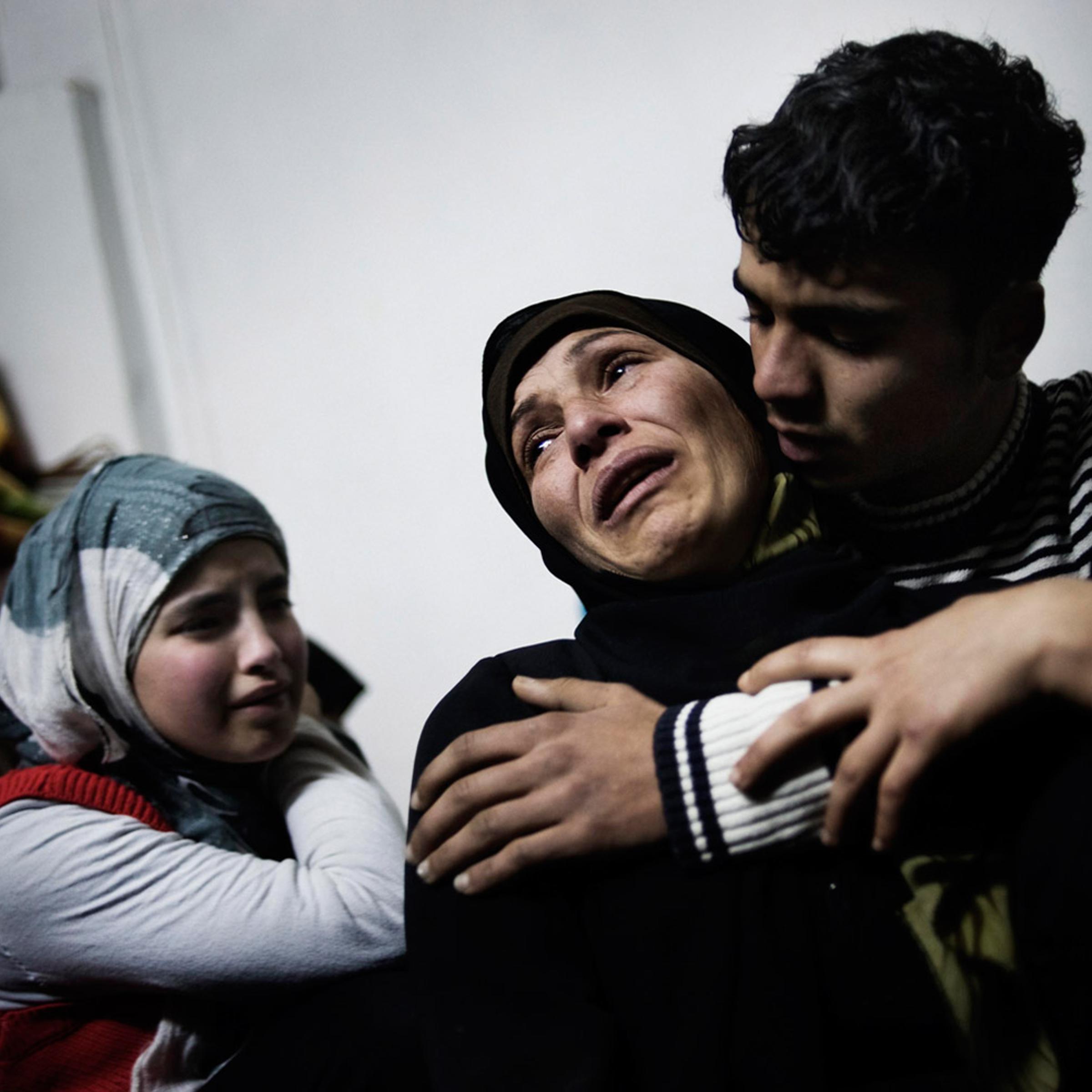 Feb. 20, 2012. A mother and her children cry over the loss of her other two sons, killed by a mortar attack launched by Al Assad forces, in Homs province.