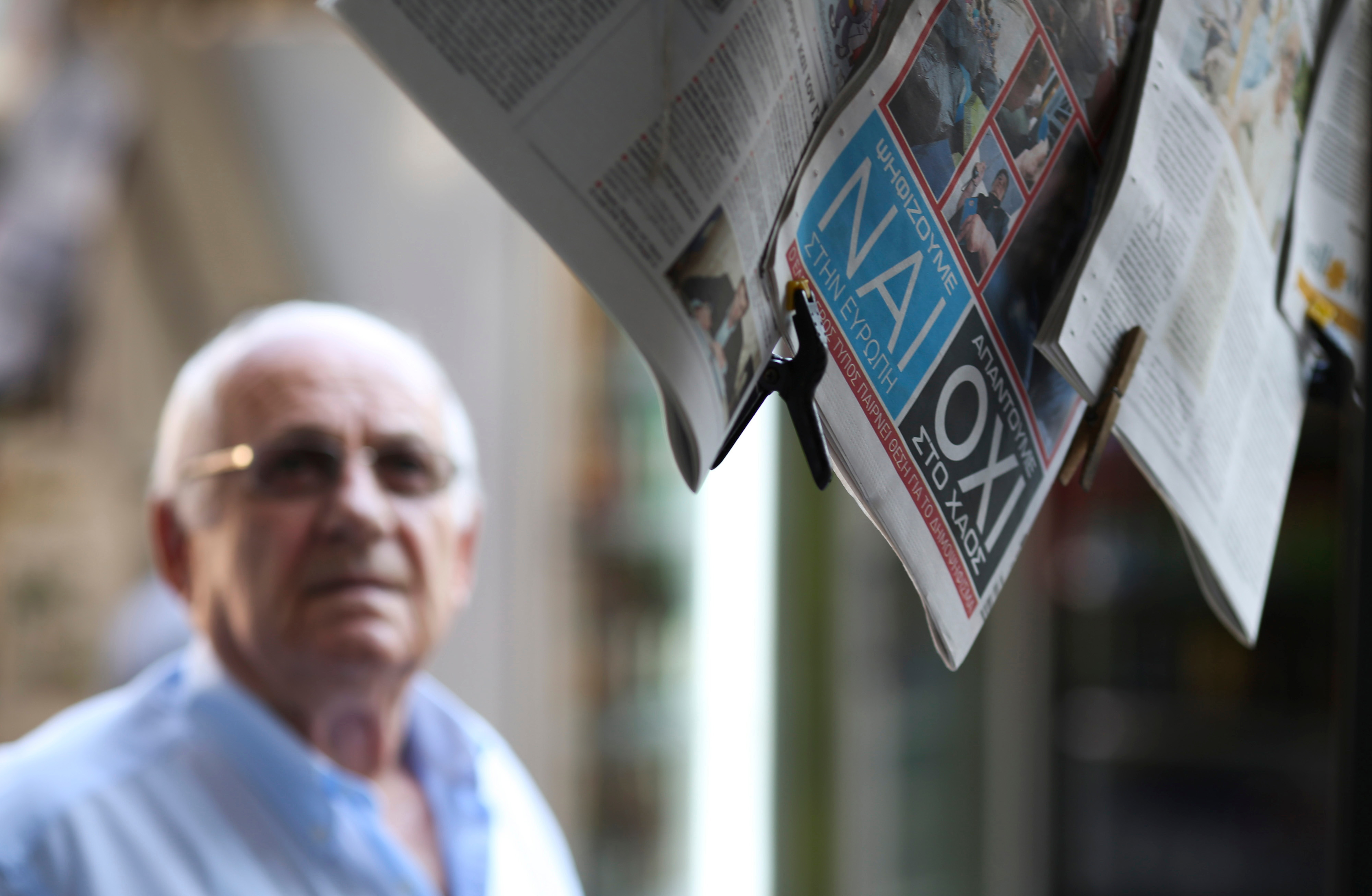 The words yes (nai) and no (oxi) sit on the back page of a newspaer hanging outside a news kiosk in the Plaka district of Athens, Greece, on Thursday, July 2, 2015. Greek voters are almost evenly split heading into a referendum in three days that Europea