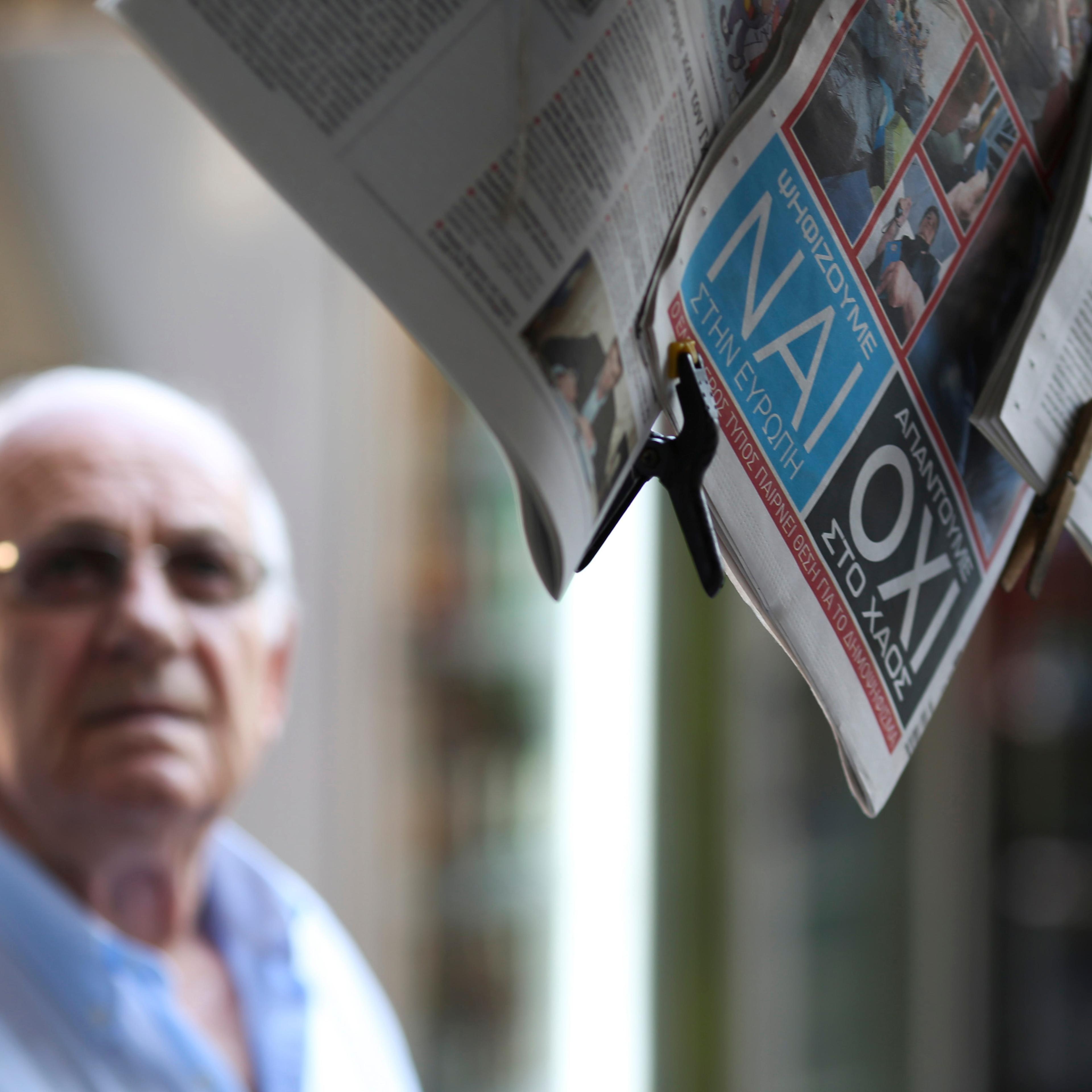 The words yes (nai) and no (oxi) sit on the back page of a newspaer hanging outside a news kiosk in the Plaka district of Athens, Greece, on Thursday, July 2, 2015. Greek voters are almost evenly split heading into a referendum in three days that Europea
