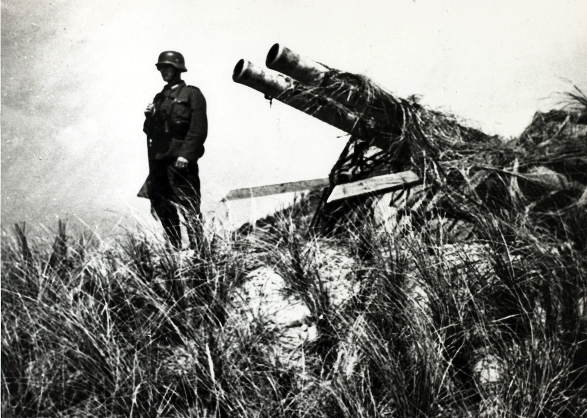 War and Conflict. World War II. pic: May 1940. A German soldier stands guard over a captured Dutch gun on the island of Texel. Germany invaded Belgium, Holland and Luxembourg in May 1940 claiming justification because they feared that the Allies, (France