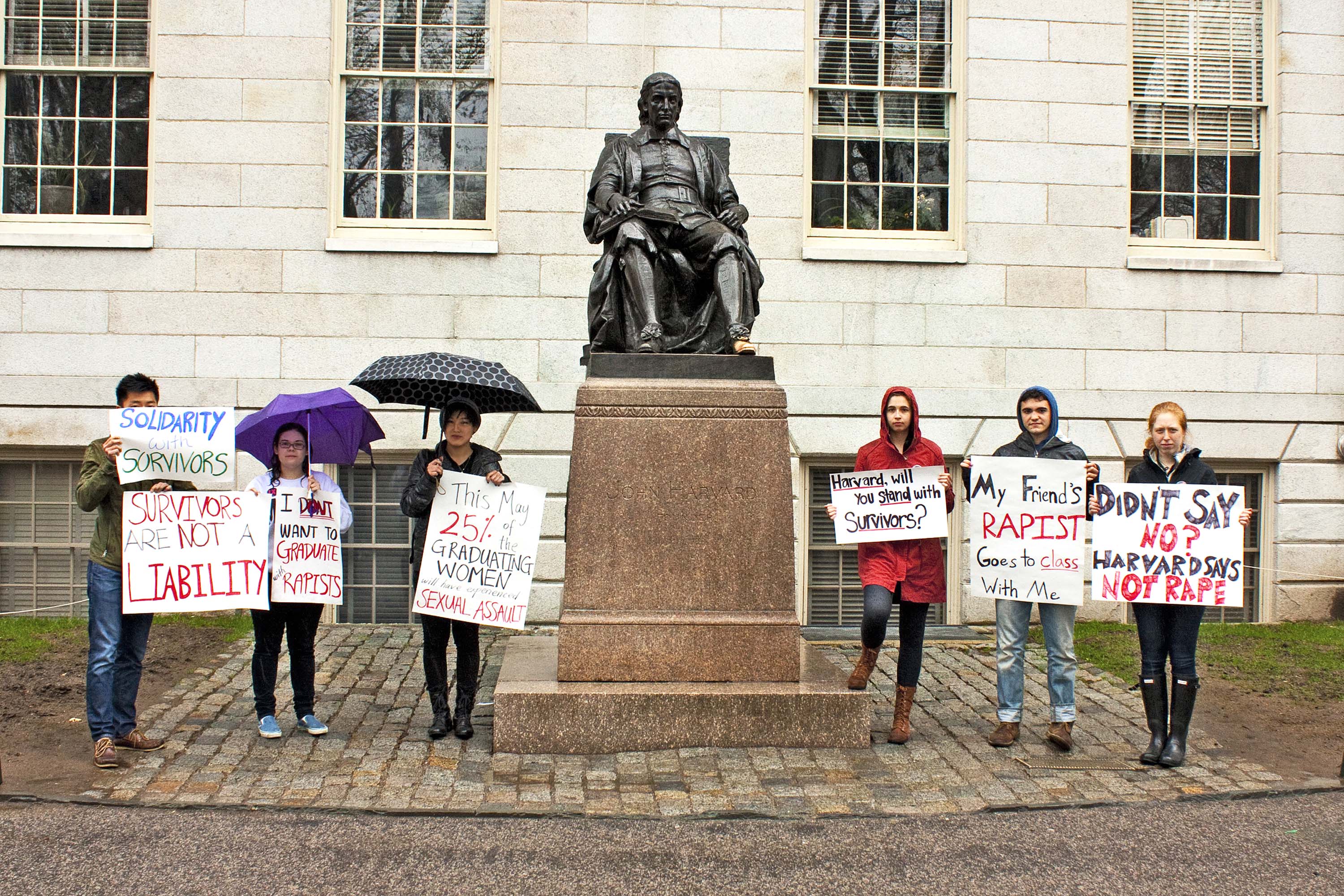 Students protest Harvard’s handling of sexual-assault allegations in front of a statue of John Harvard in April.
