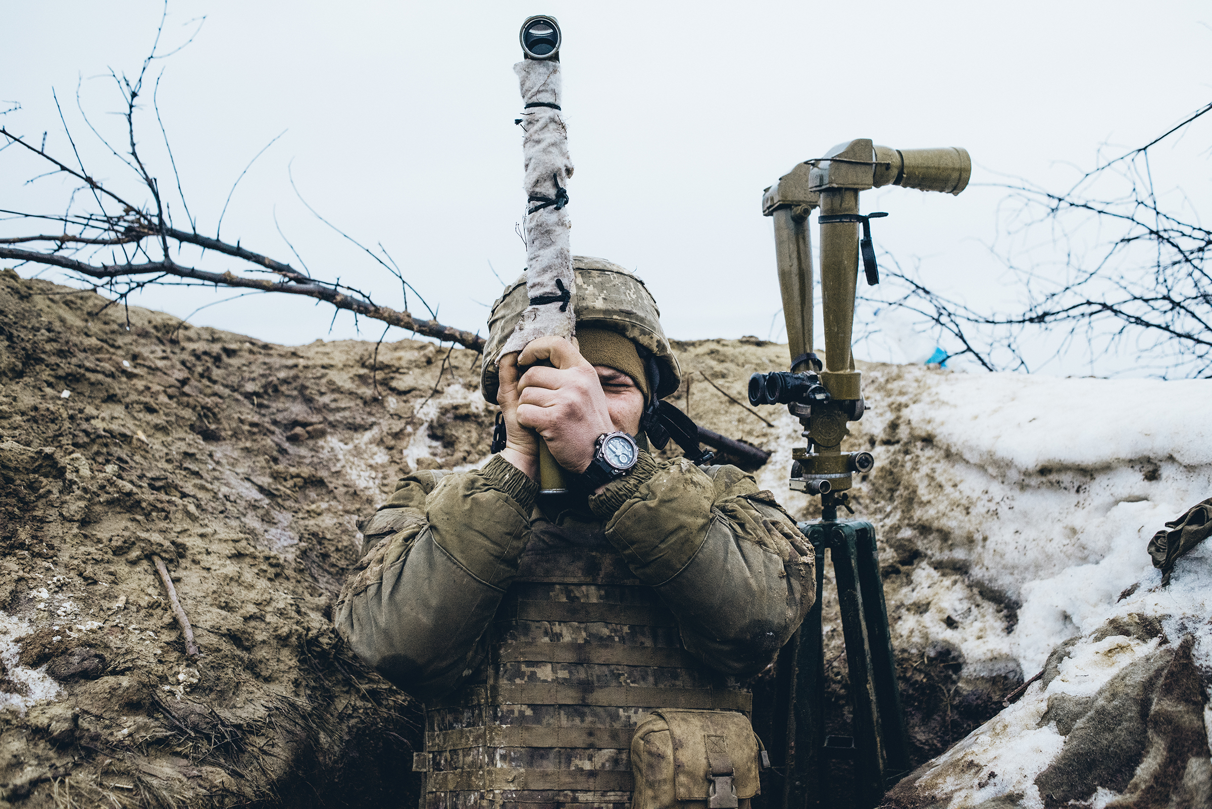 A Ukrainian soldier observes pro-Russian forces amassed on the front line in the breakaway Donetsk region of Ukraine on Feb. 8, 2022.