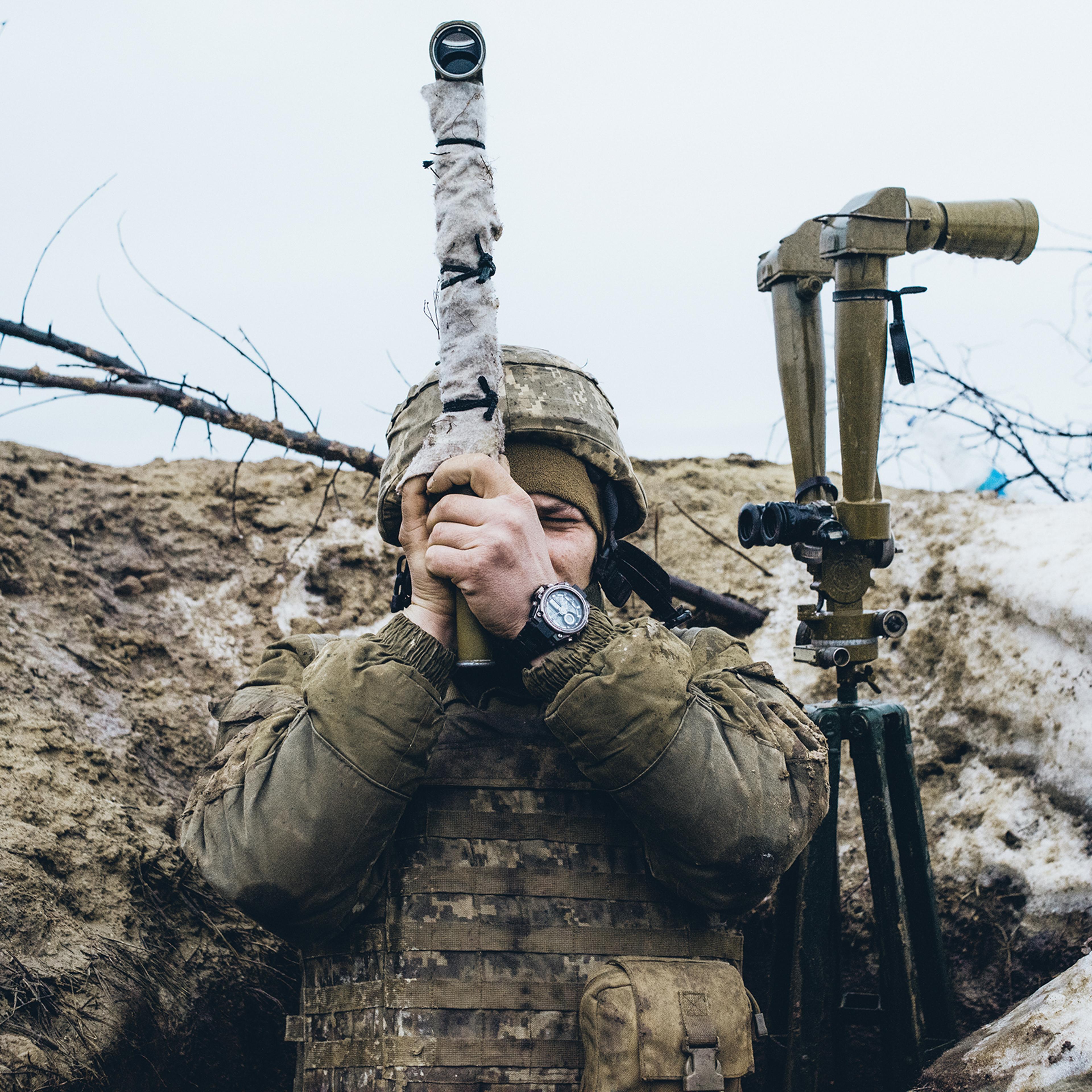 A Ukrainian soldier observes pro-Russian forces amassed on the front line in the breakaway Donetsk region of Ukraine on Feb. 8, 2022.
