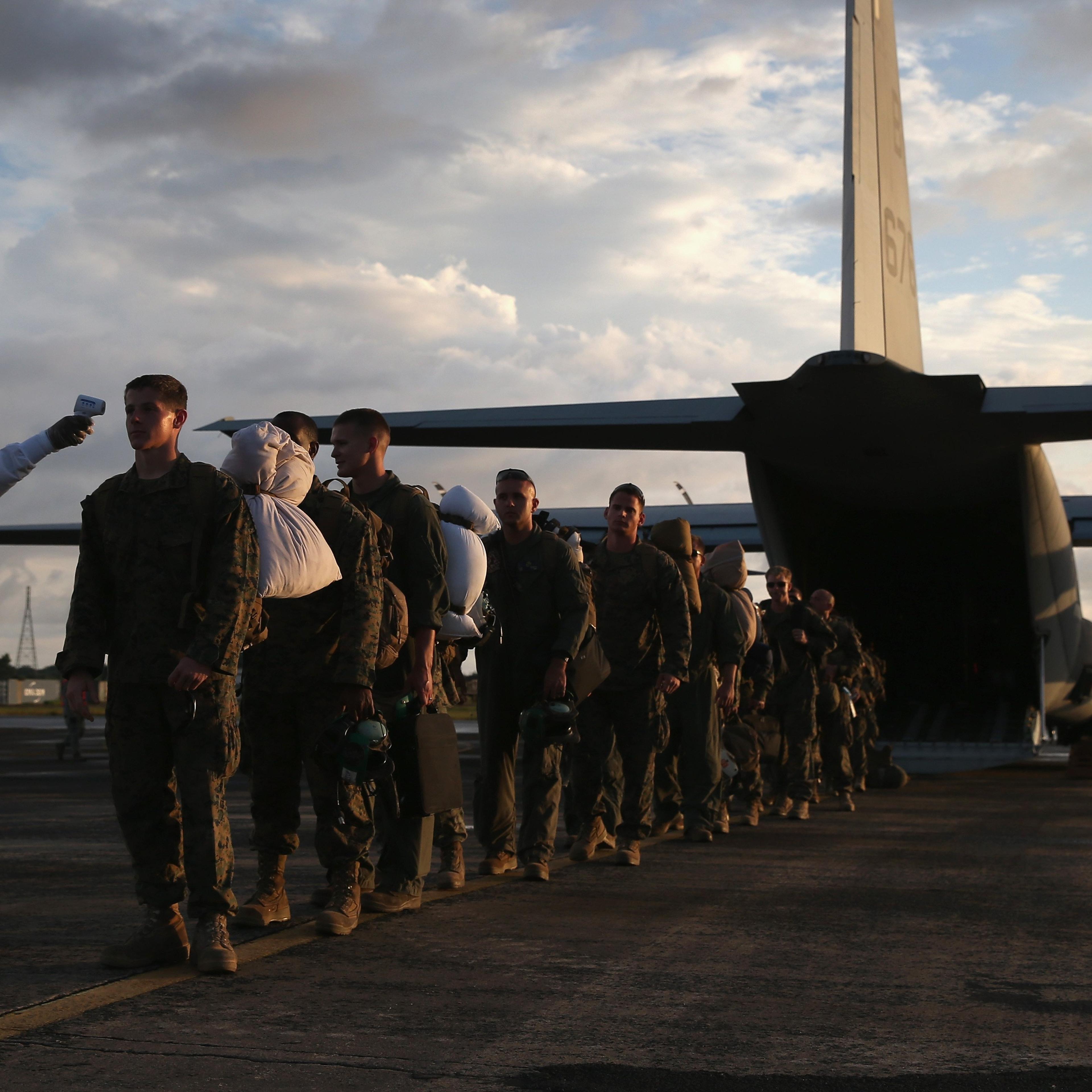 A health worker takes the temperature of U.S. Marines arriving to take part in Operation United Assistance on Oct. 9, 2014 near Monrovia, Liberia.