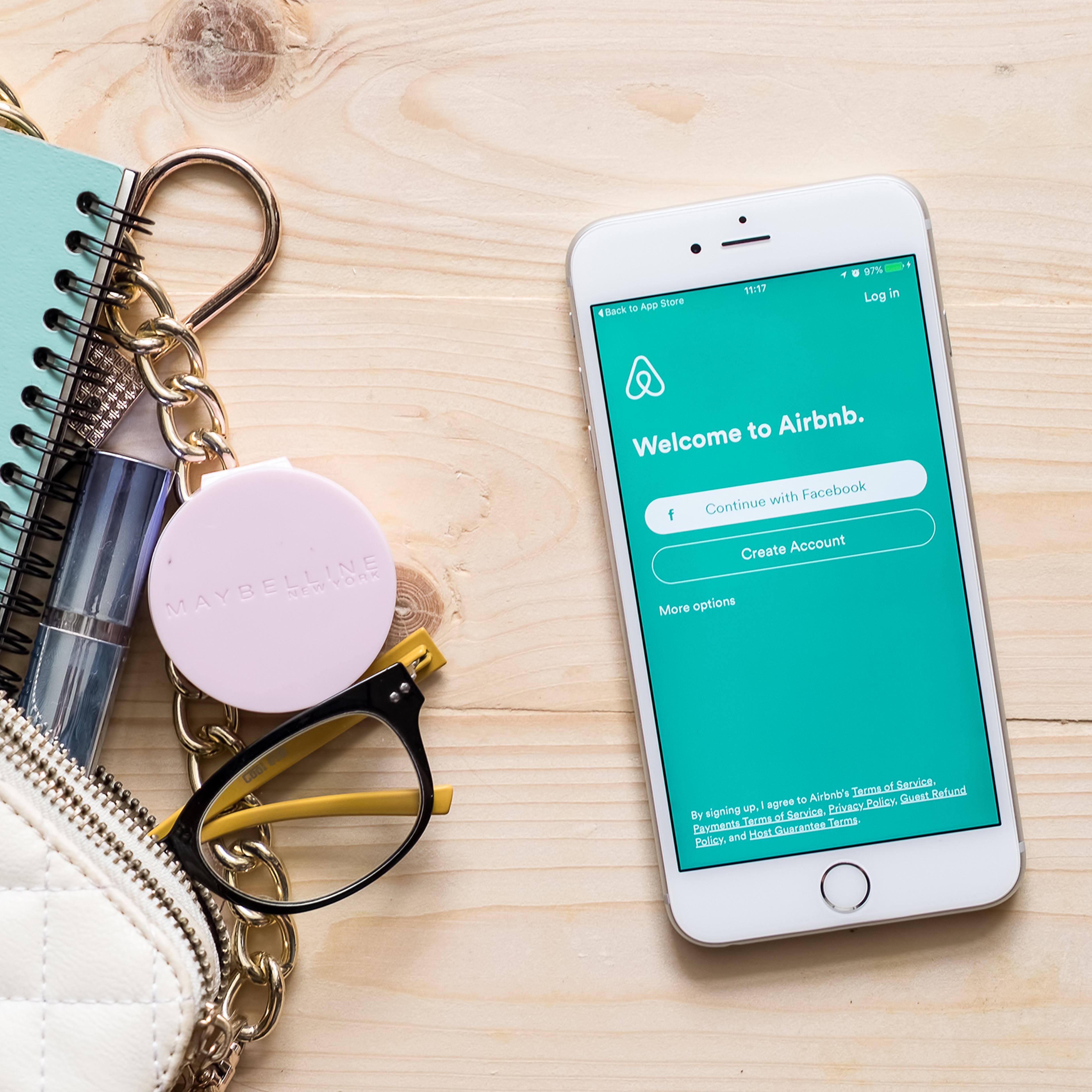Apple iPhone 6s plus with Airbnb application on the screen.