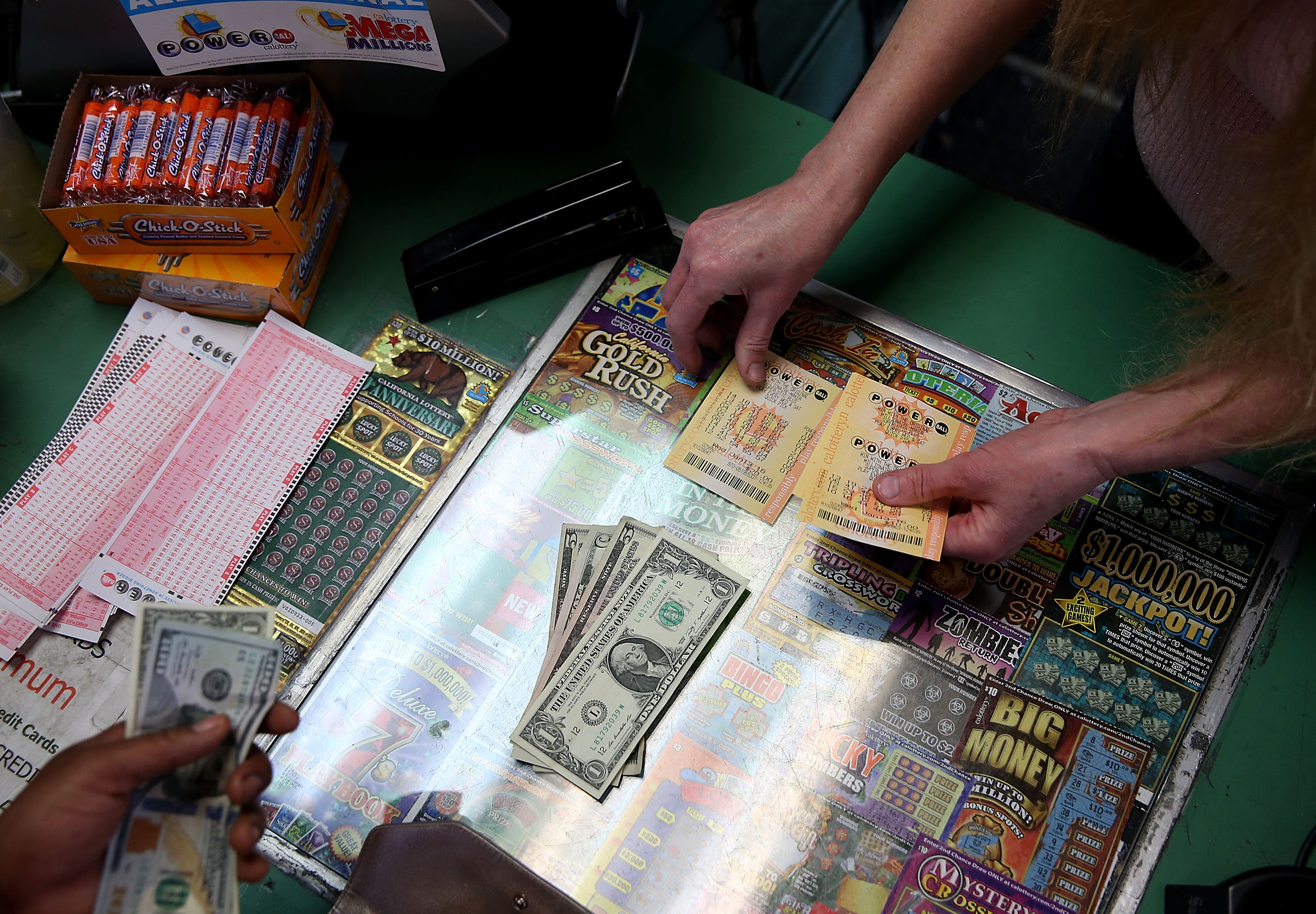 A customer buys Powerball tickets at Kavanagh Liquors on January 13, 2016 in San Lorenzo, California.