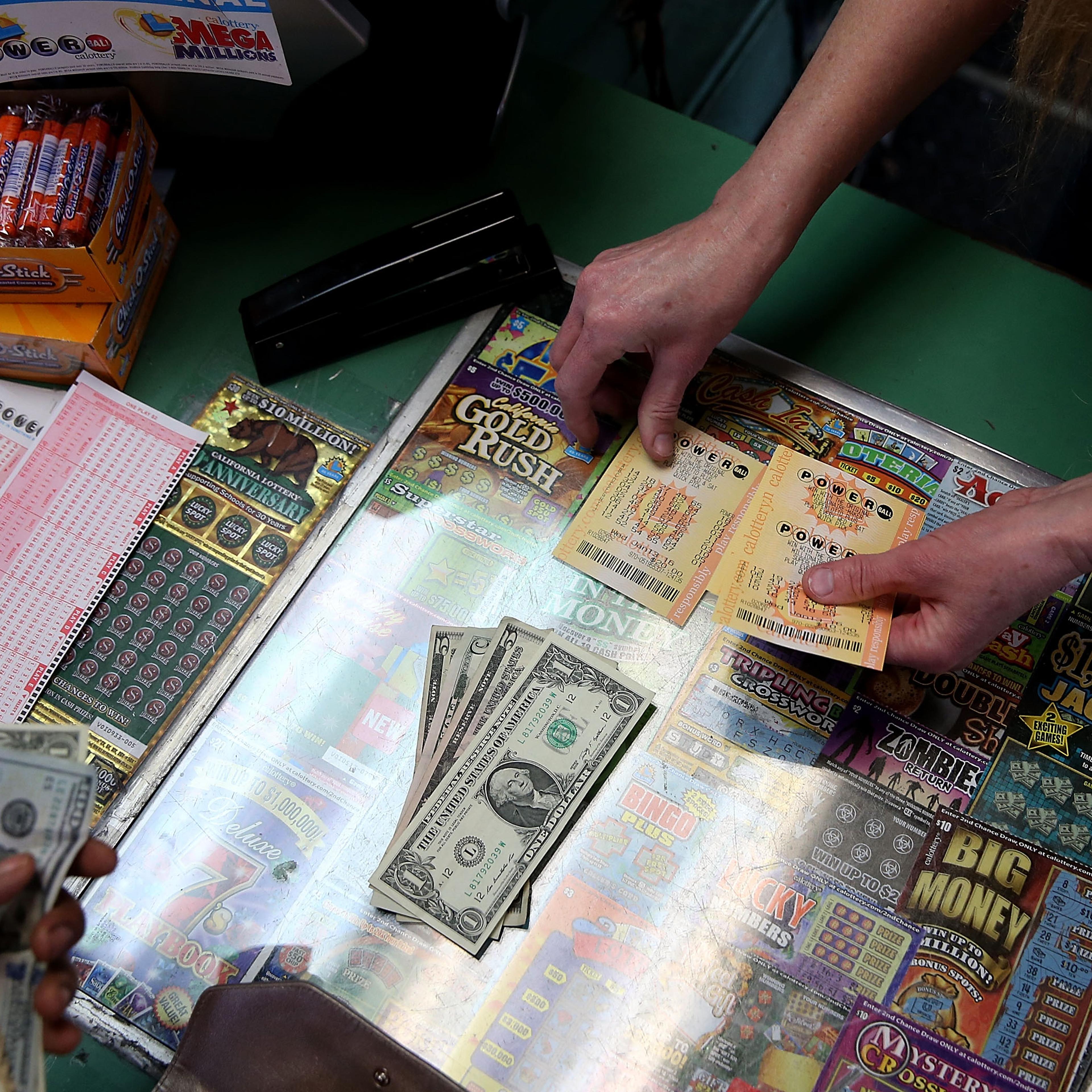 A customer buys Powerball tickets at Kavanagh Liquors on January 13, 2016 in San Lorenzo, California.