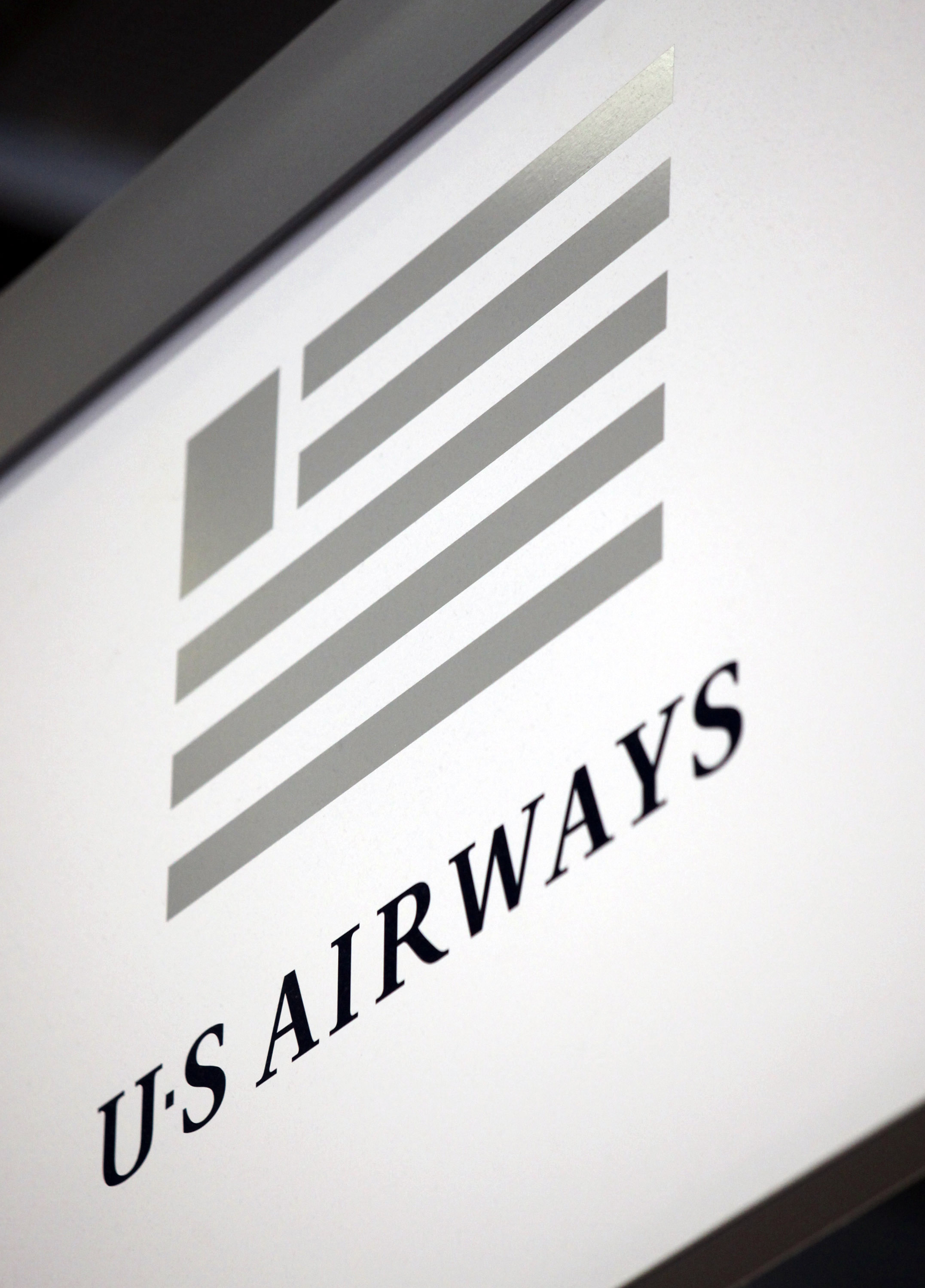 The US Airways logo hangs near a ticket counter at O'Hare International Airport in Chicago