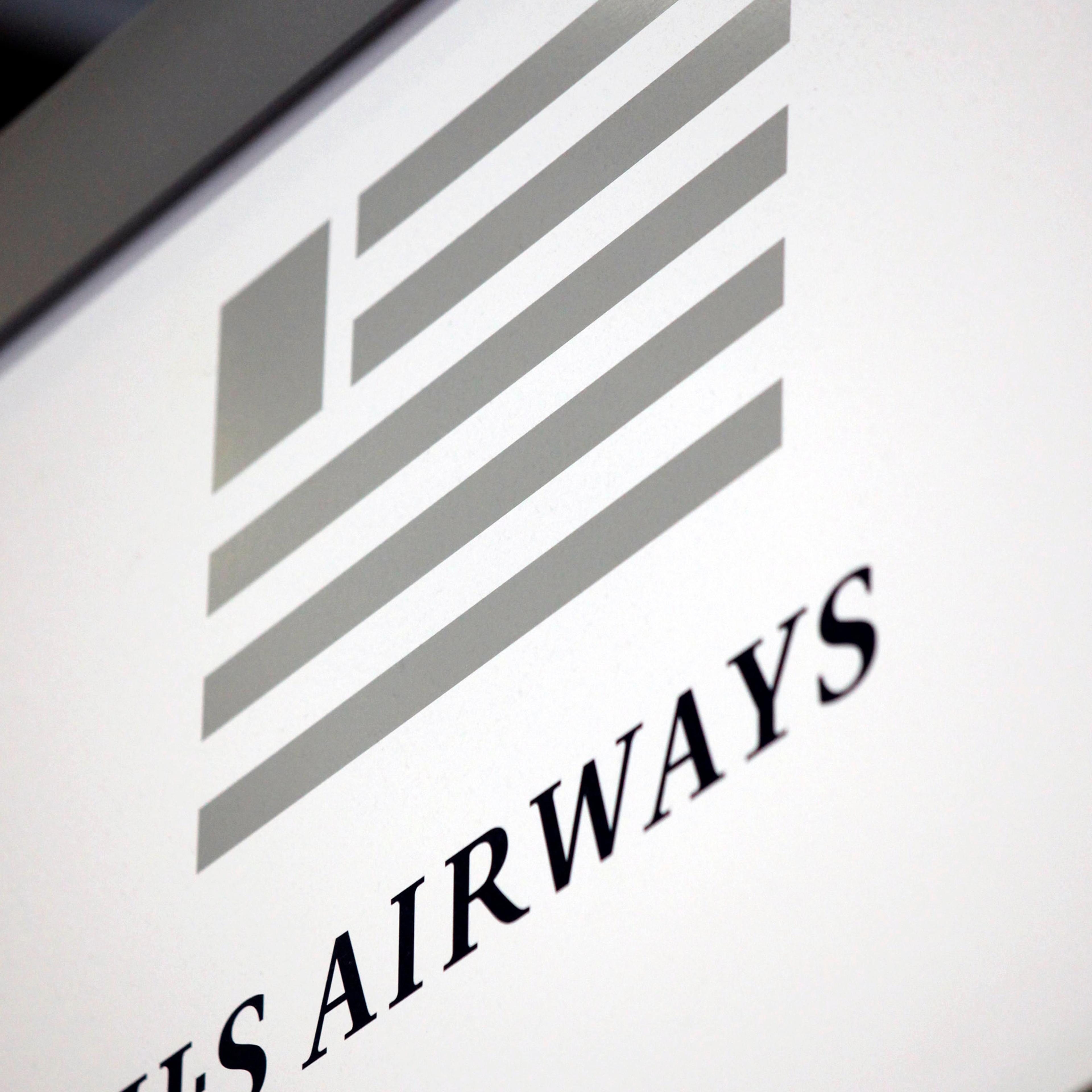 The US Airways logo hangs near a ticket counter at O'Hare International Airport in Chicago