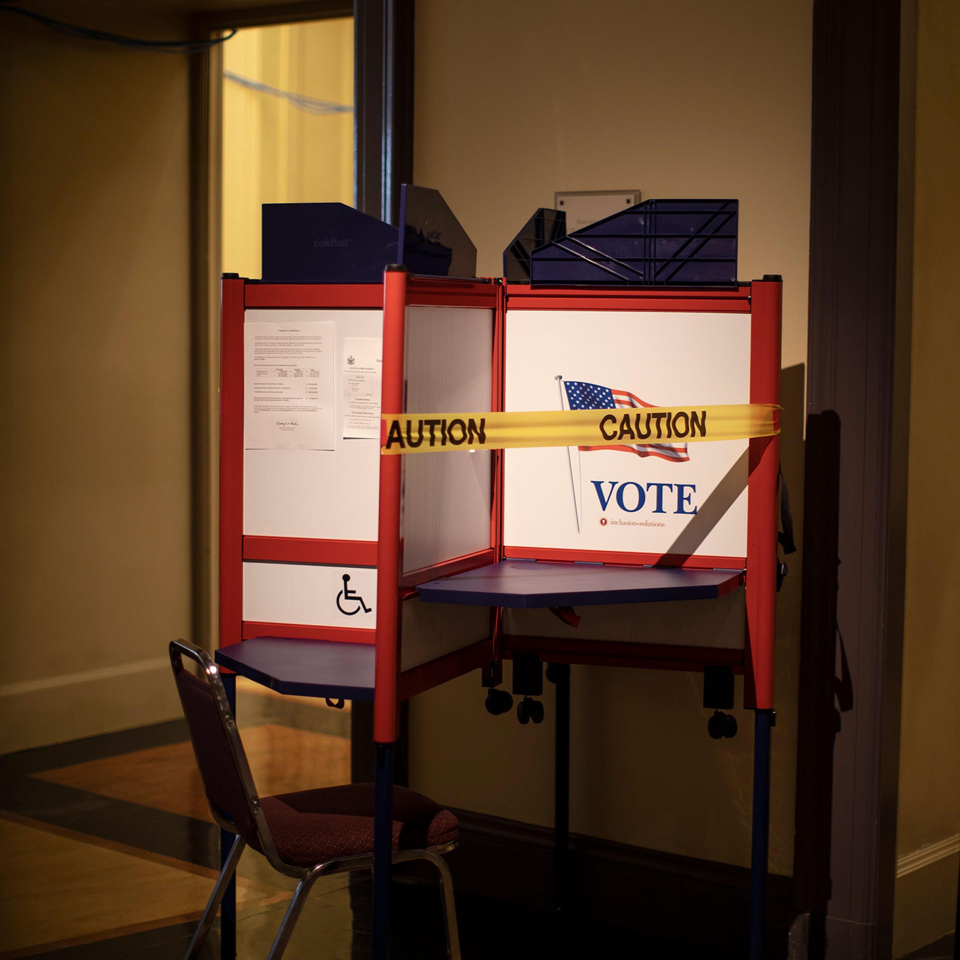 A voting booth is taped off to ensure social distancing during in-person absentee voting in Portland on June 23, 2020.