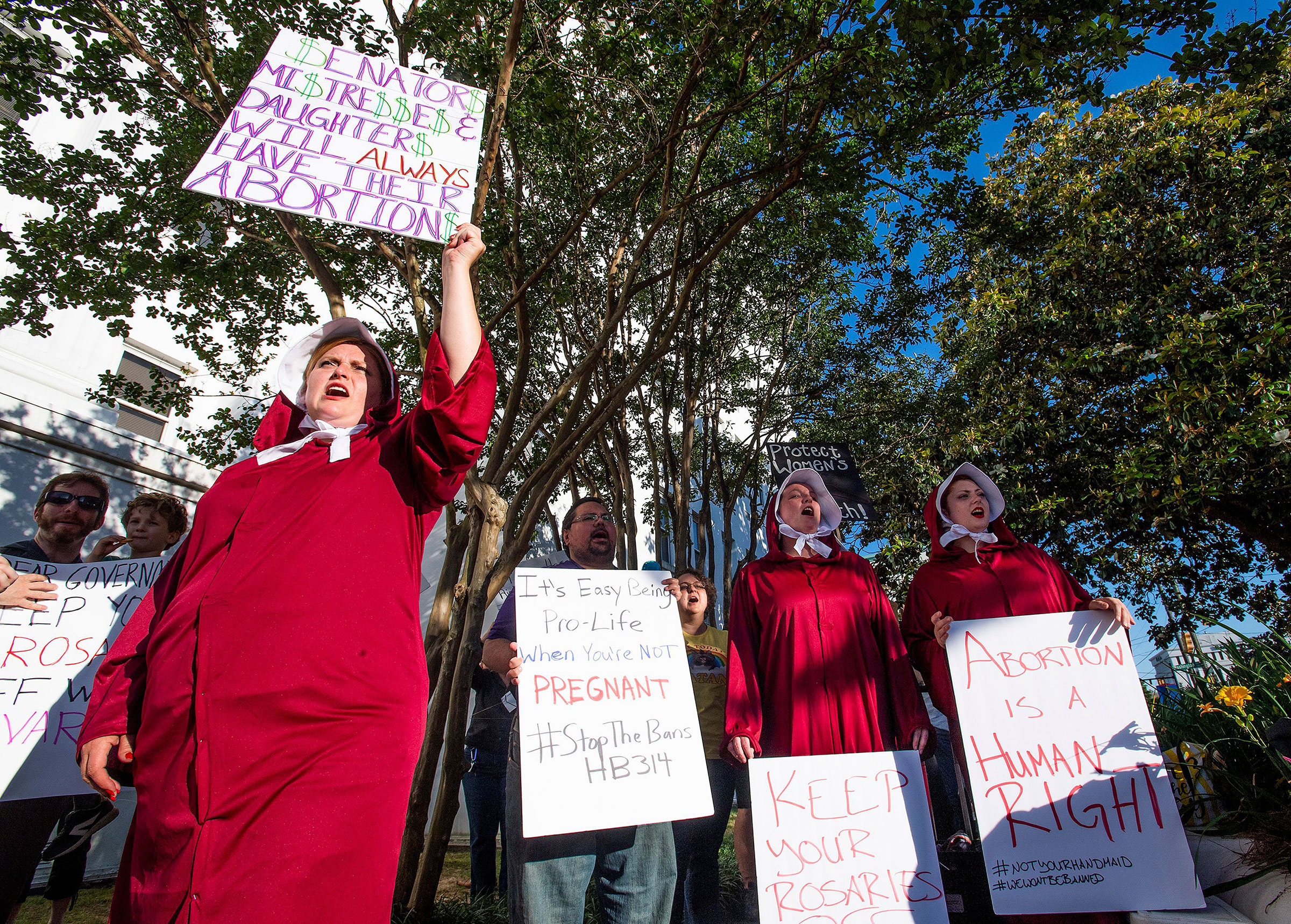 Bianca Cameron-Schwiesow, left, chants during a rally against HB314, the near-total ban on abortion bill, outside of the Alabama