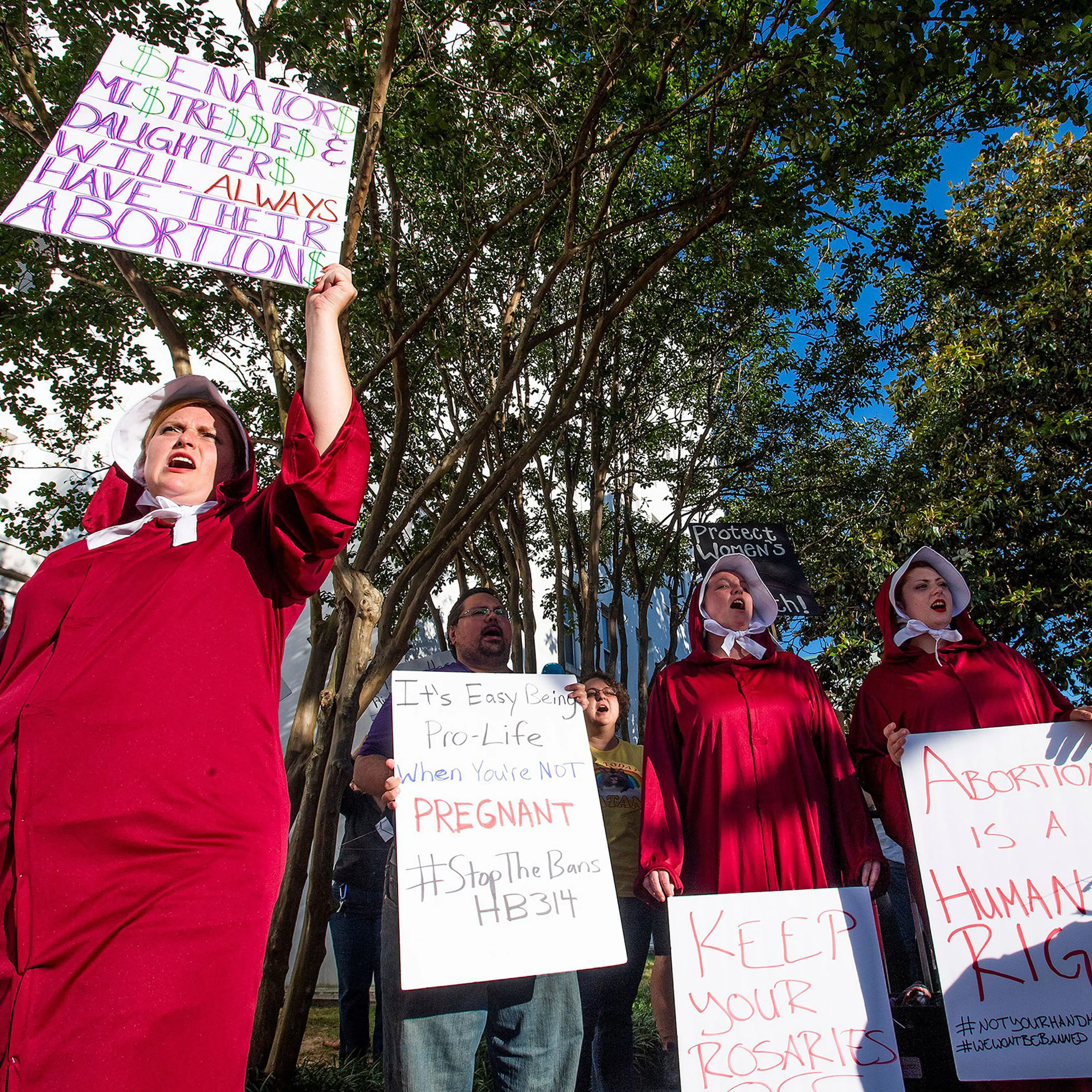 Bianca Cameron-Schwiesow, left, chants during a rally against HB314, the near-total ban on abortion bill, outside of the Alabama