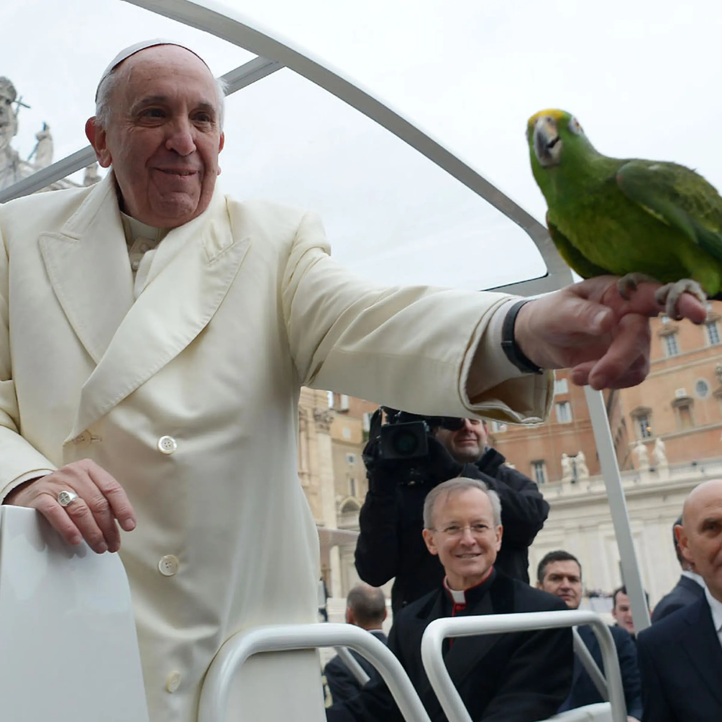 Pope Francis holds a parrot shown by a pilgrim as he arrives for his general audience at St Peter's square on January 29, 2014 at the Vatican.