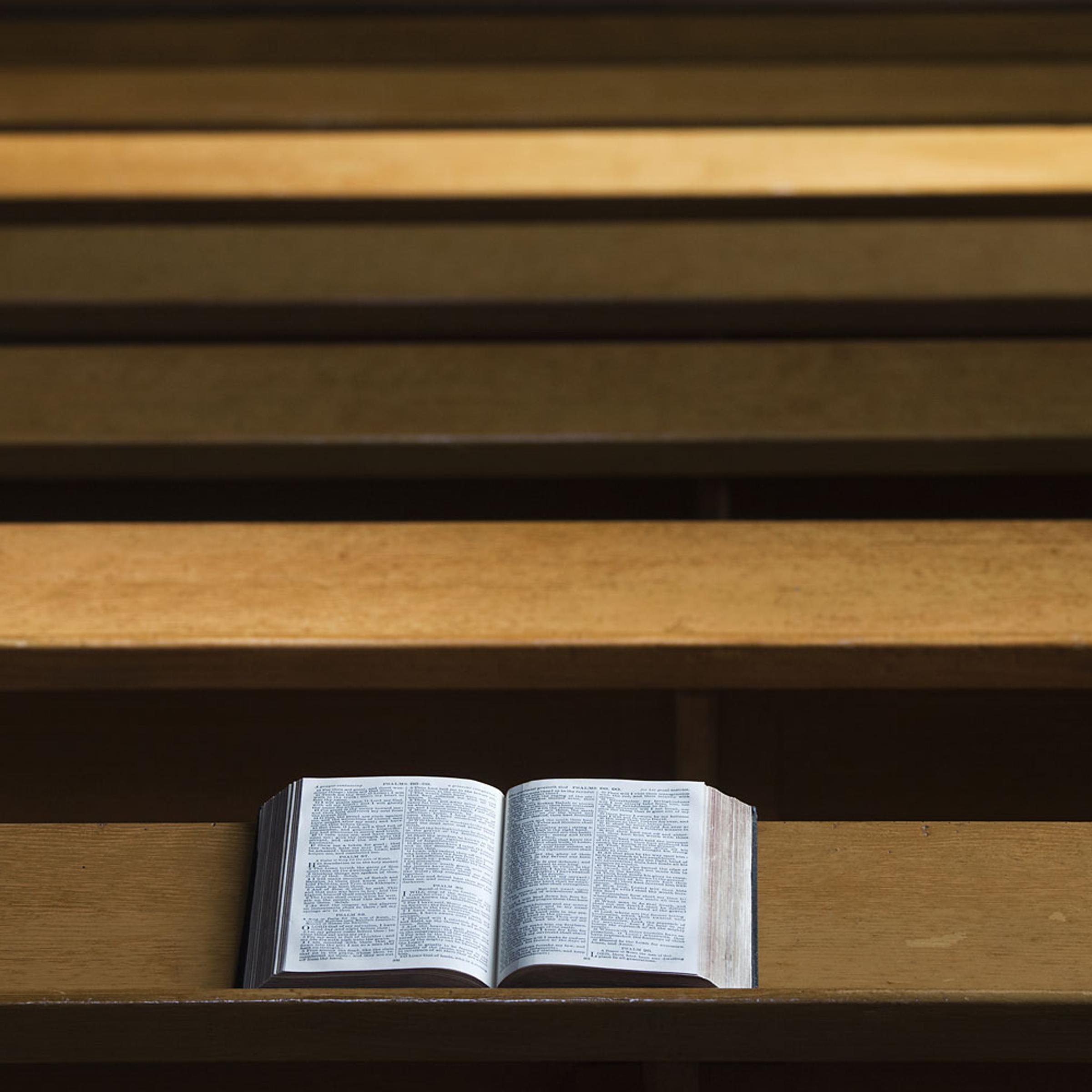A Bible Open On A Wooden Bench
