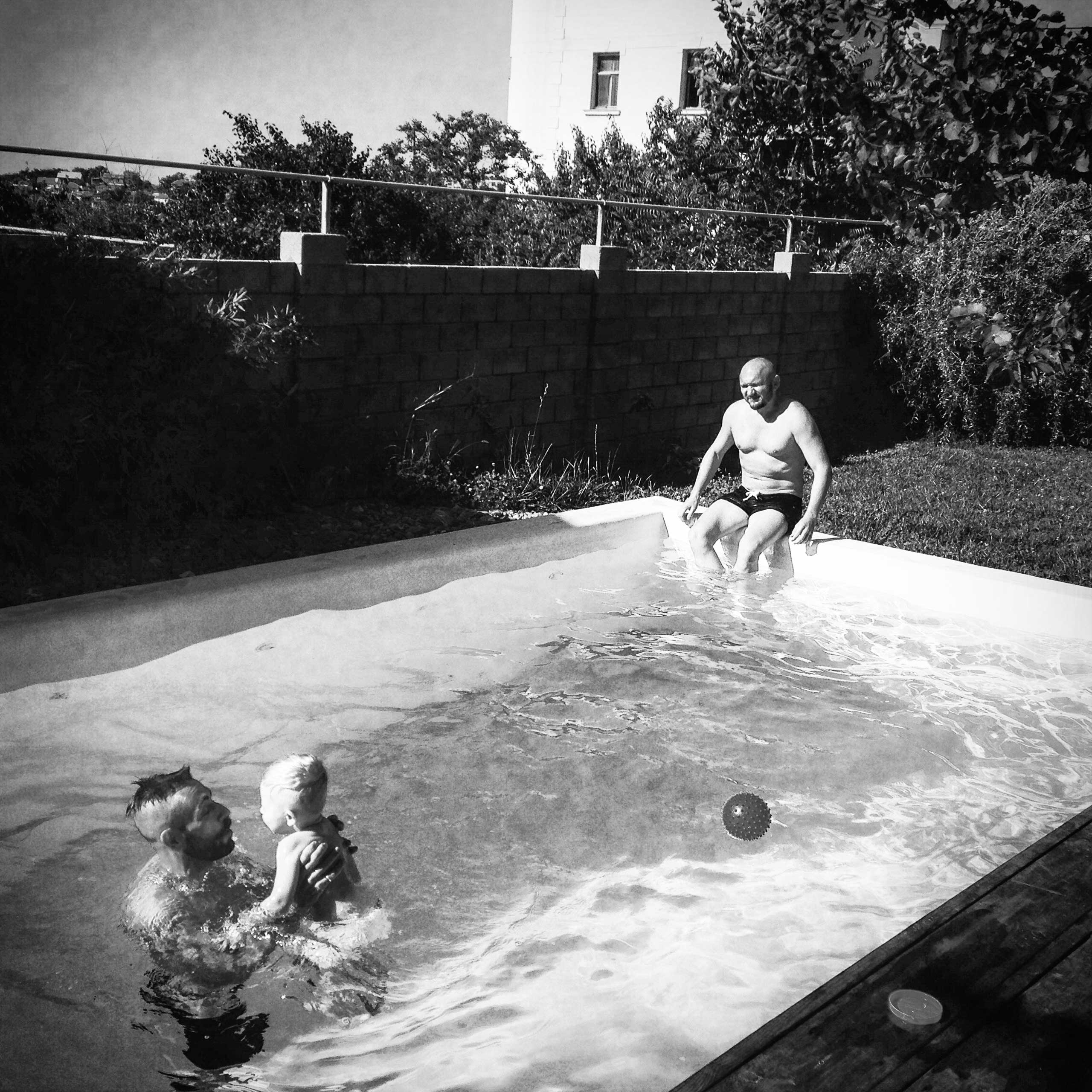 Yegor watches as Bogdan teaches Timur to swim at their home in Sevastopol.