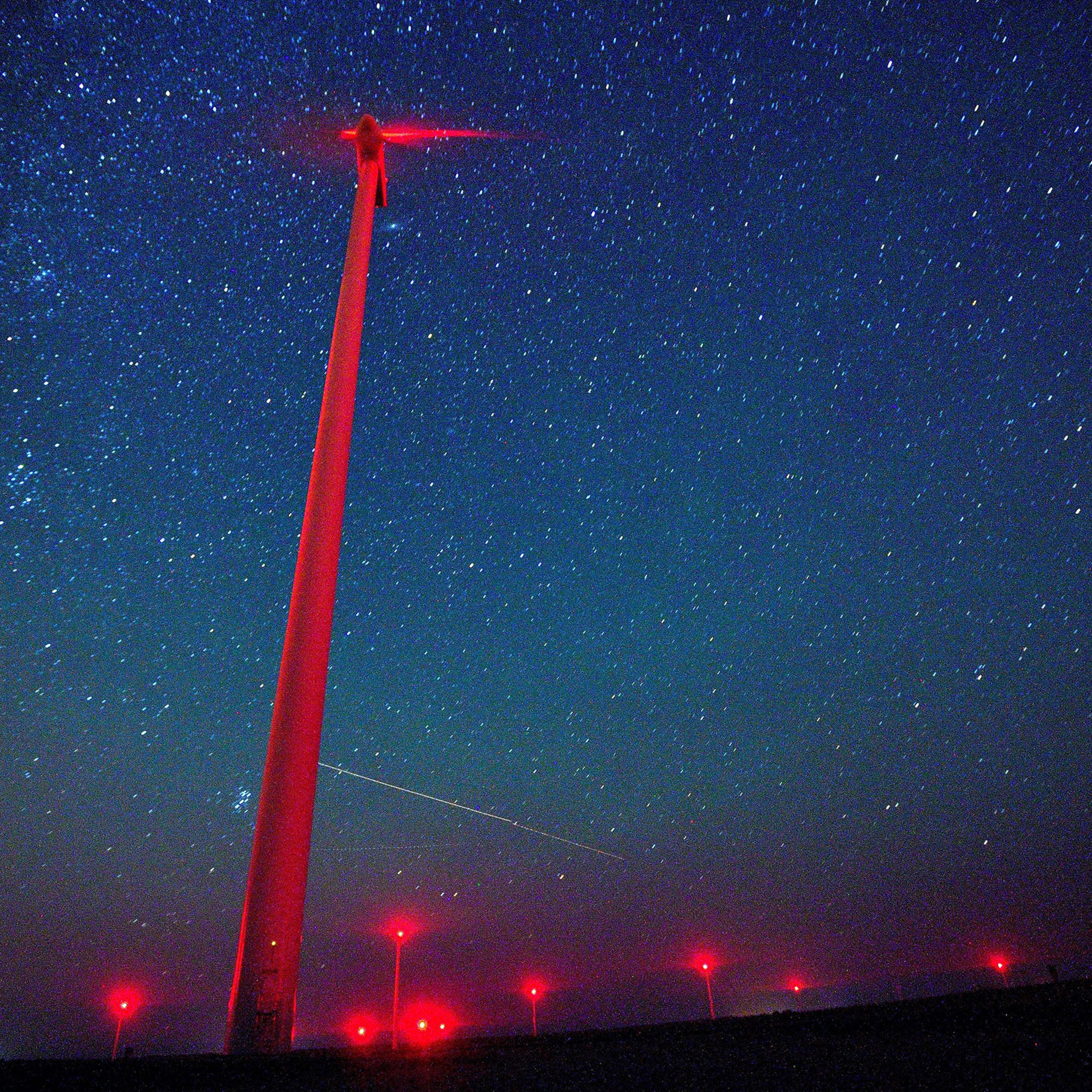 A view of meteors lighting up the night sky above a wind turbine at 'Saint Nikola' wind park near the Kavarna, some 500km from Sofia, Bulgaria, Aug. 12, 2016.