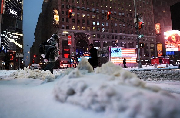 People make their way through Times Square in New York during a winter storm on March 14, 2017.