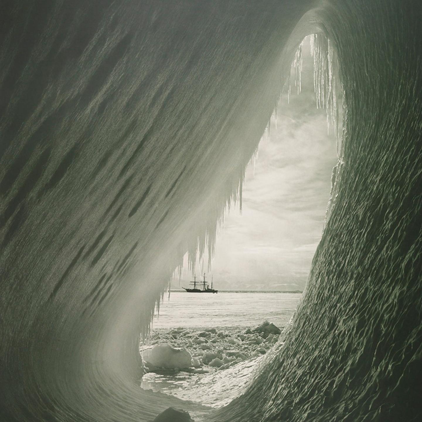 An ice grotto, framing the Terra Nova. Ponting was struck by the colors of the ice inside the grotto, which were a mix of blues, purples and greens on January 5, 1911.