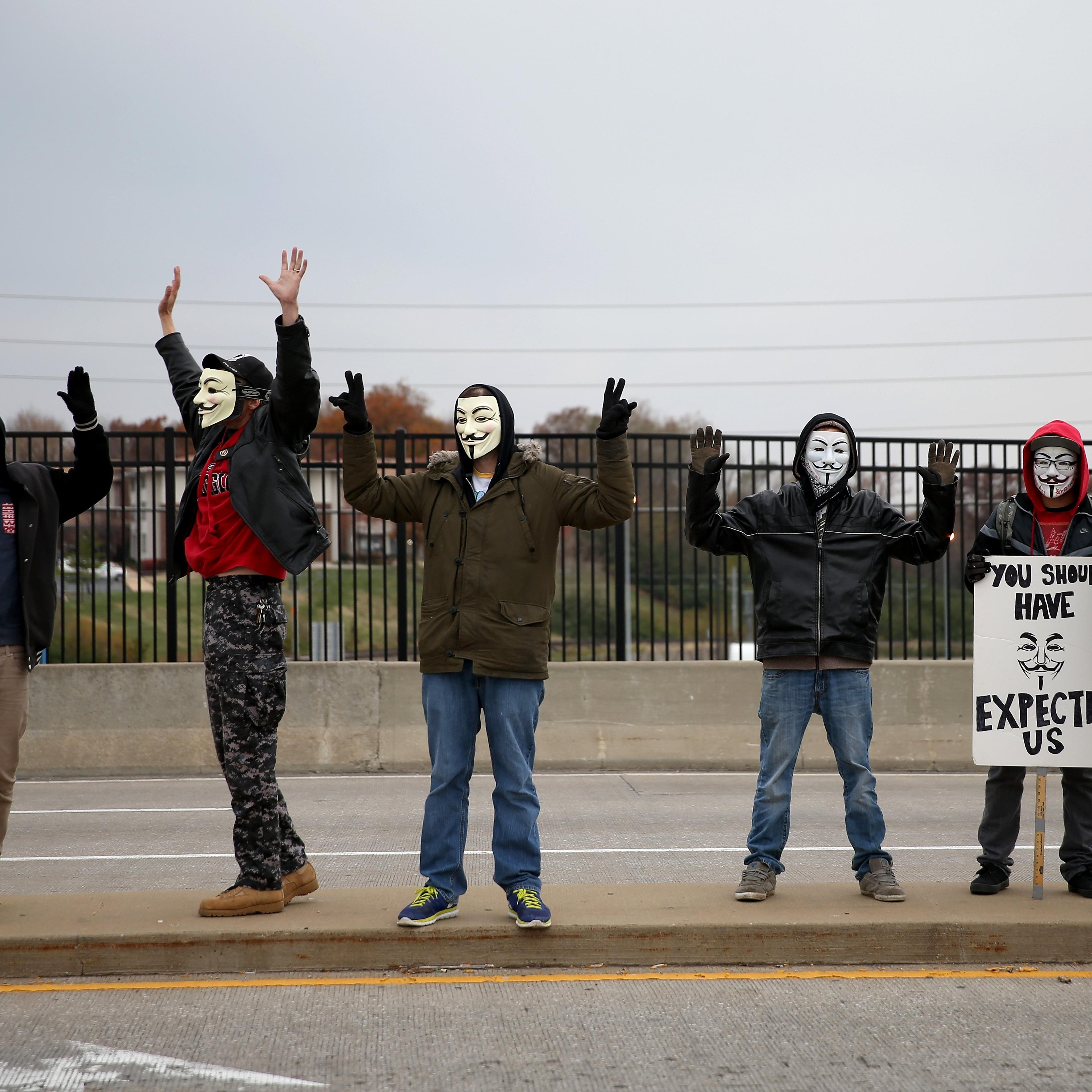 Demonstrators yell "Hands Up, Don't Shoot" alongside a highway overpass to voice their opinions as the area awaits a grand jury decision on Nov. 15, 2014 near Ferguson, Missouri.